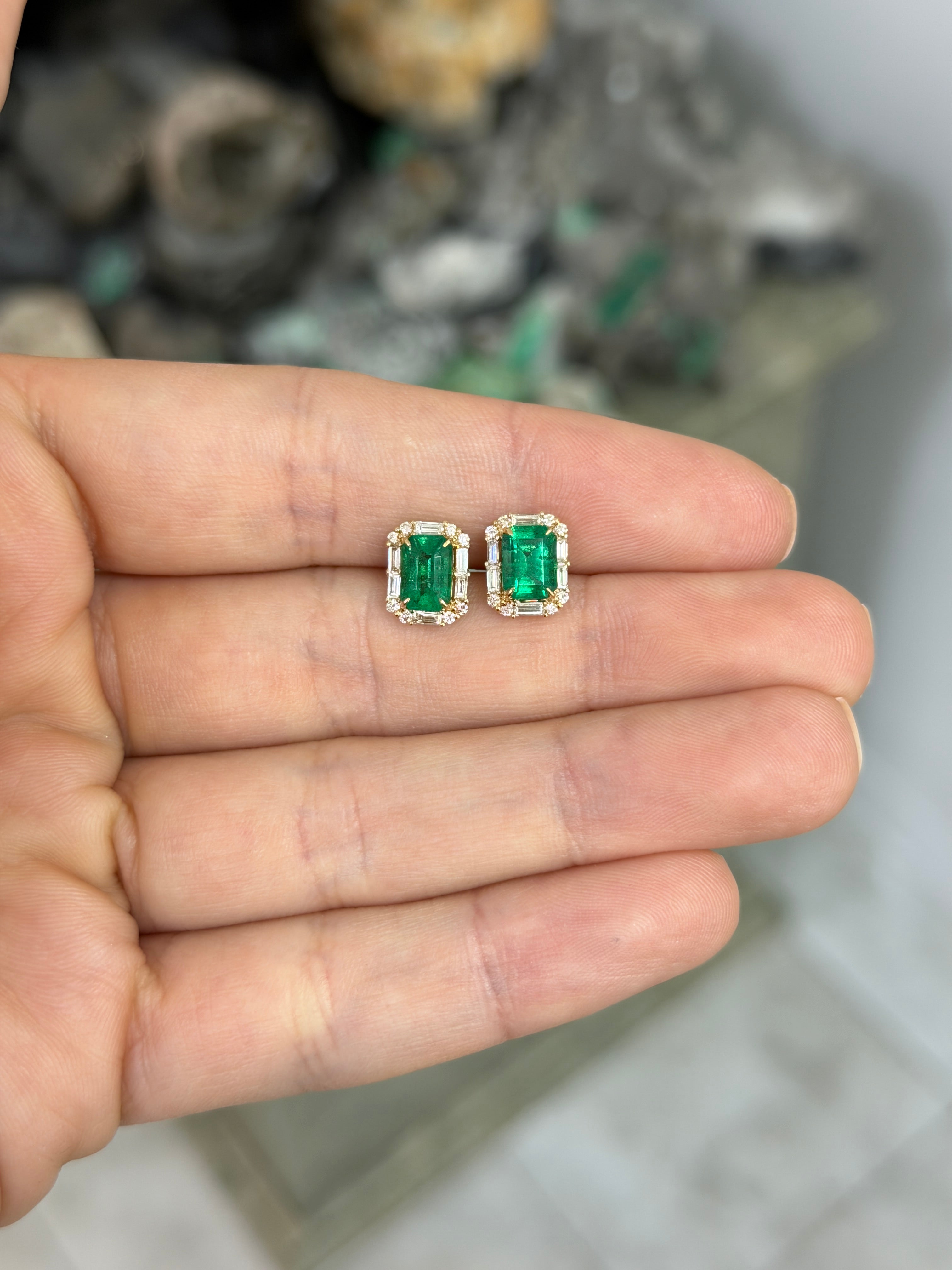 18K gold emerald and diamond halo stud earrings with rich green emeralds and baguette diamonds, by JR Colombian Emeralds.