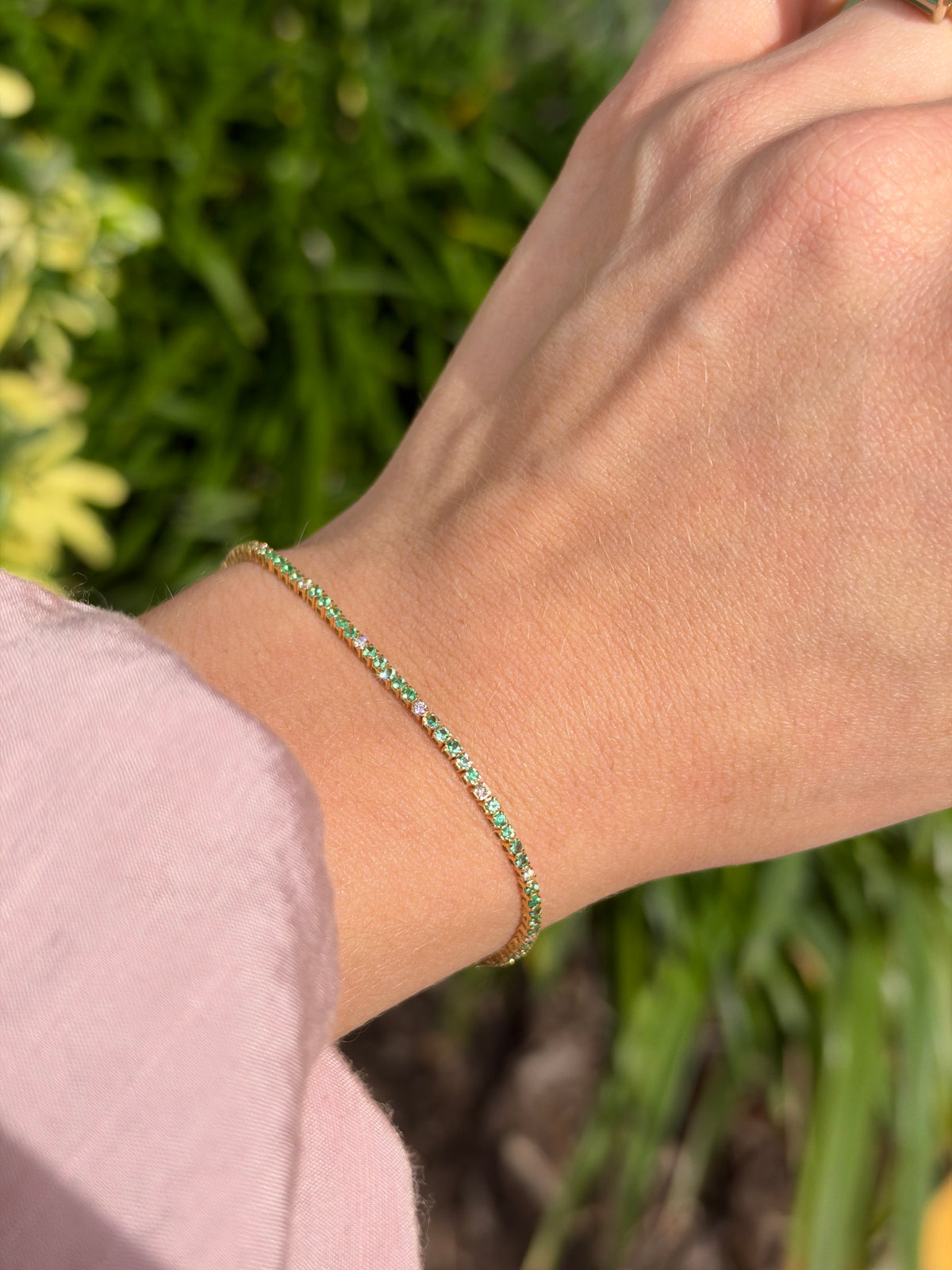 Petite 1.14tcw emerald and diamond tennis bracelet in 14K yellow gold, 7-inch length, featuring emerald and diamond accents.