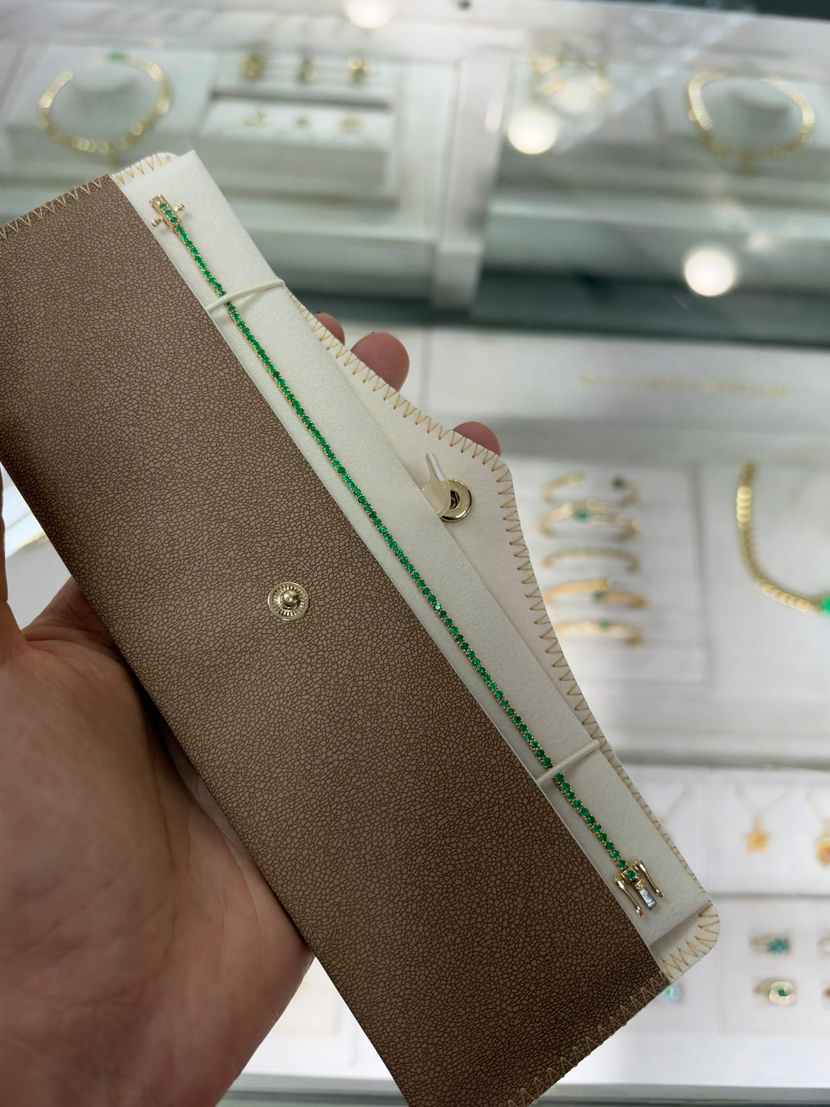 Petite 1.72tcw round emerald tennis bracelet in 14K gold by JR Colombian Emeralds, 7-inch length, showcasing emeralds and gold links.