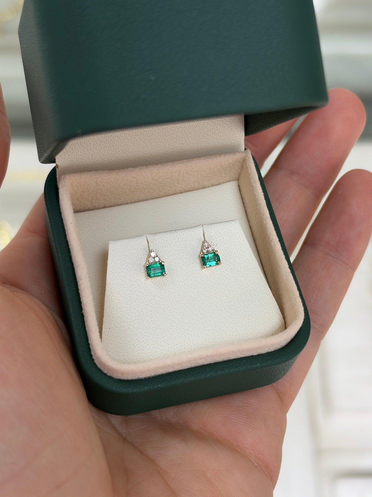 14K gold petite emerald and diamond stud earrings featuring a natural green emerald and small diamonds, from JR Colombian Emeralds.