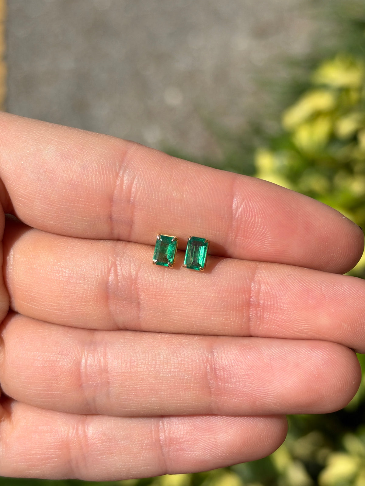Medium green Zambian emerald cut stud earrings with 1.0tcw total weight in 14K gold, featuring classic rectangular shape.