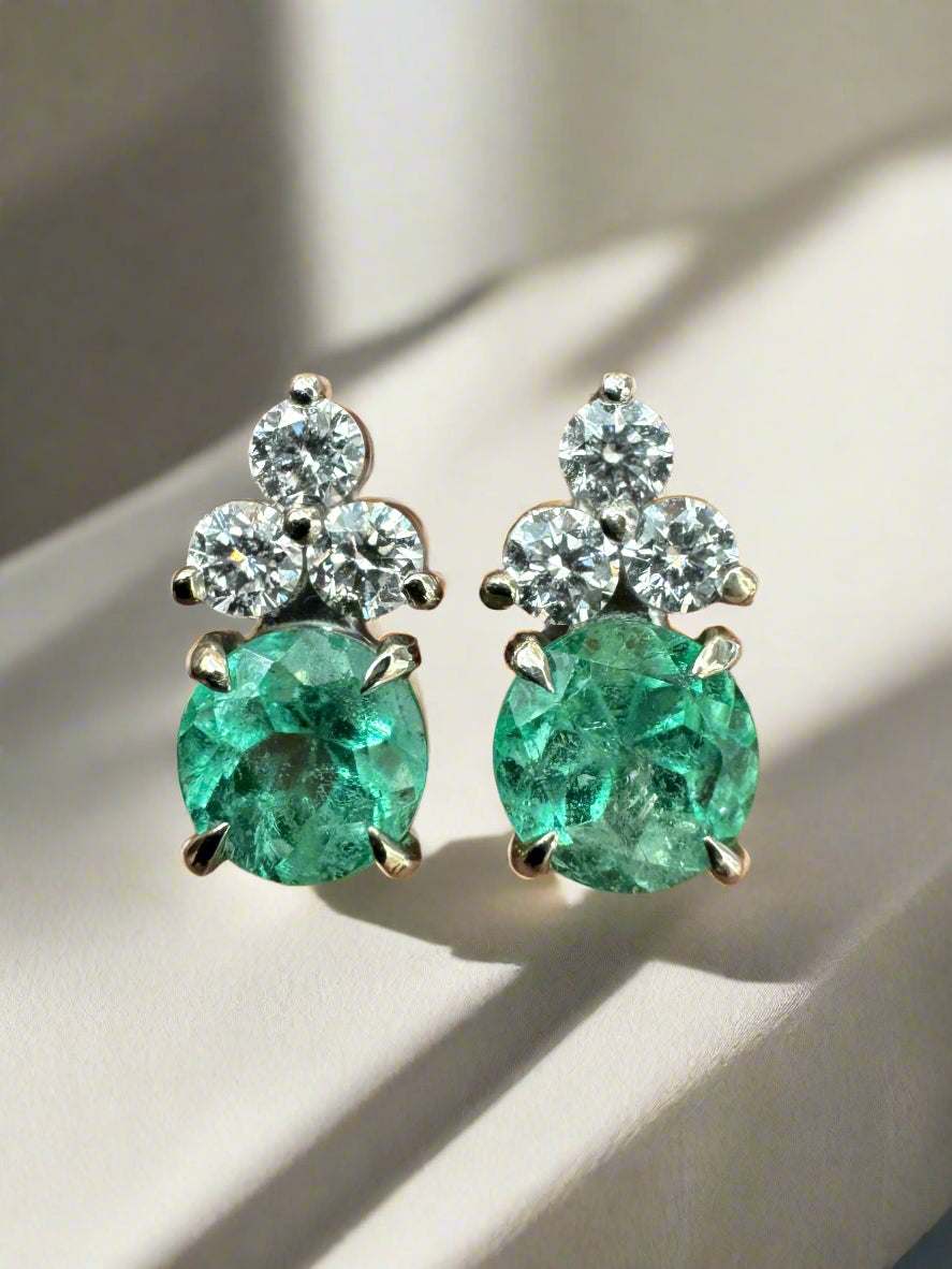 Colombian emerald and diamond trio stud earrings set in 14K white gold with round cut green emeralds and brilliant round diamonds