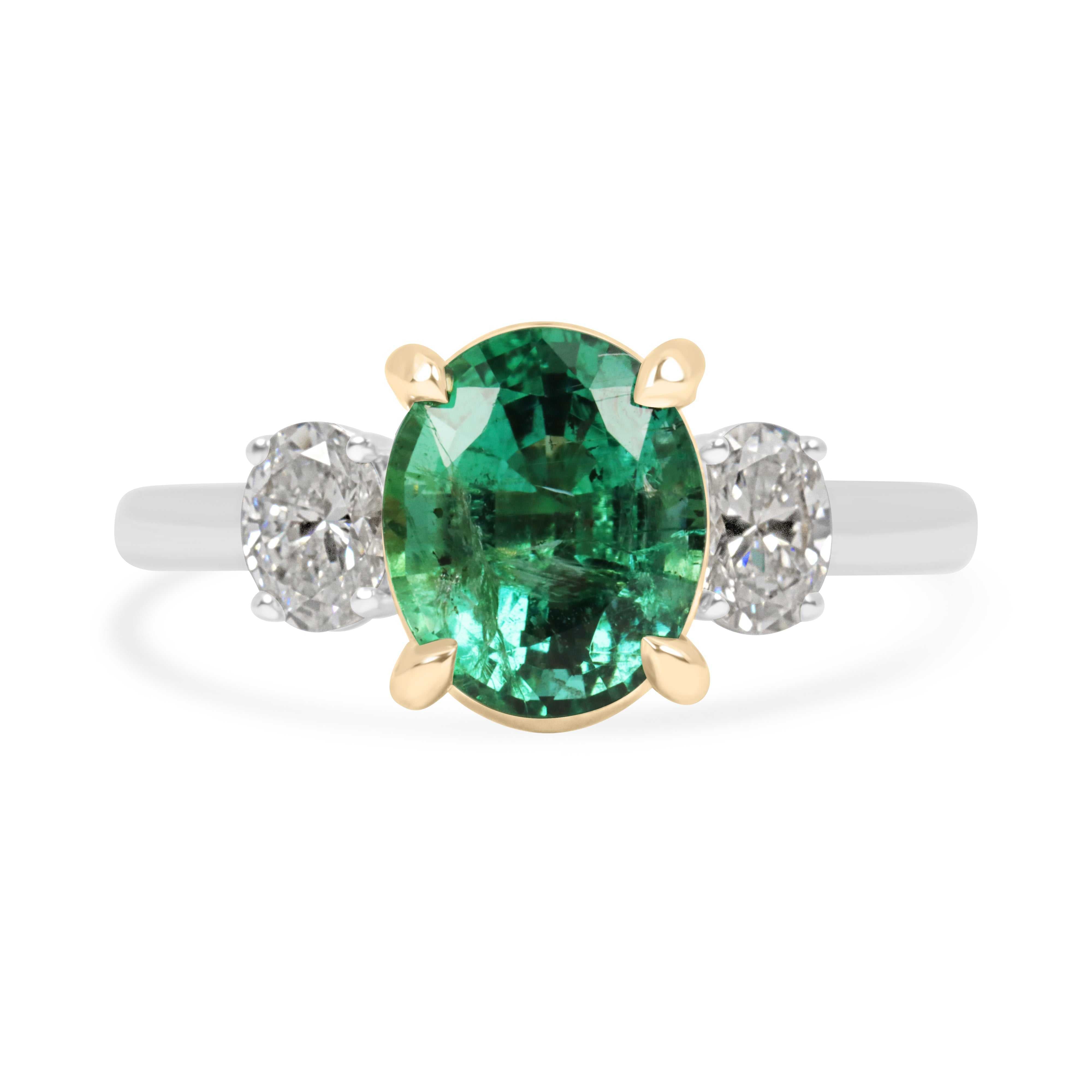 Vibrant oval emerald three stone engagement ring with platinum and 14K gold setting and oval lab diamonds