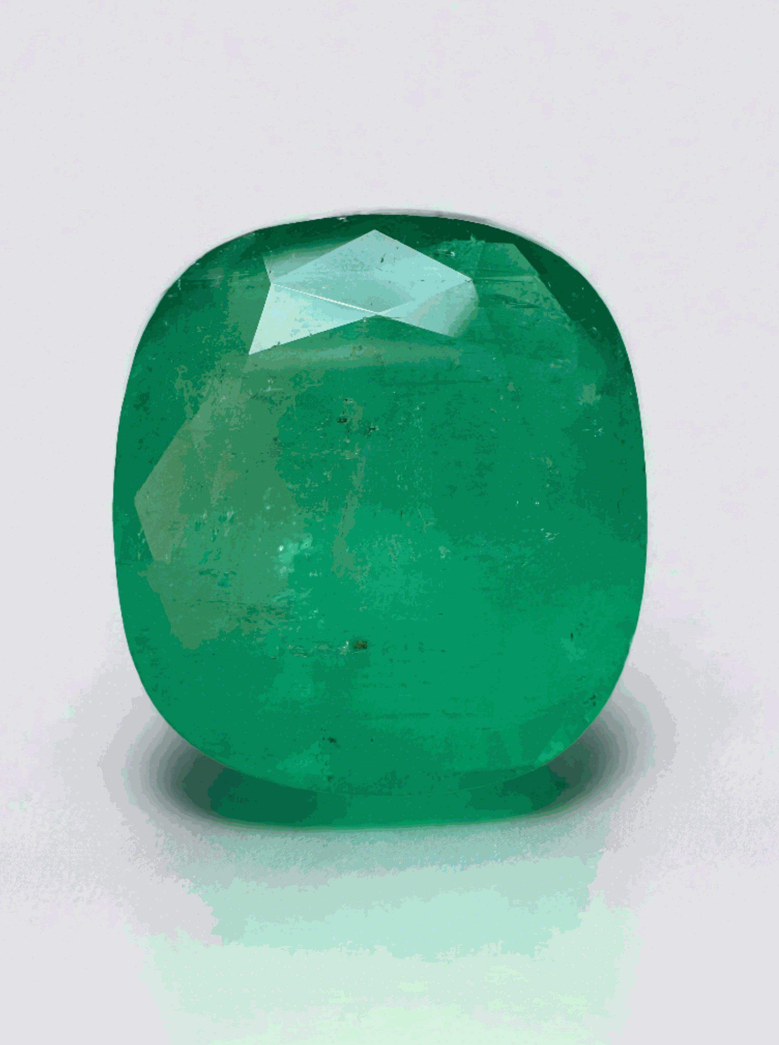 Large 21.62 carat cushion cut Colombian emerald, medium green.