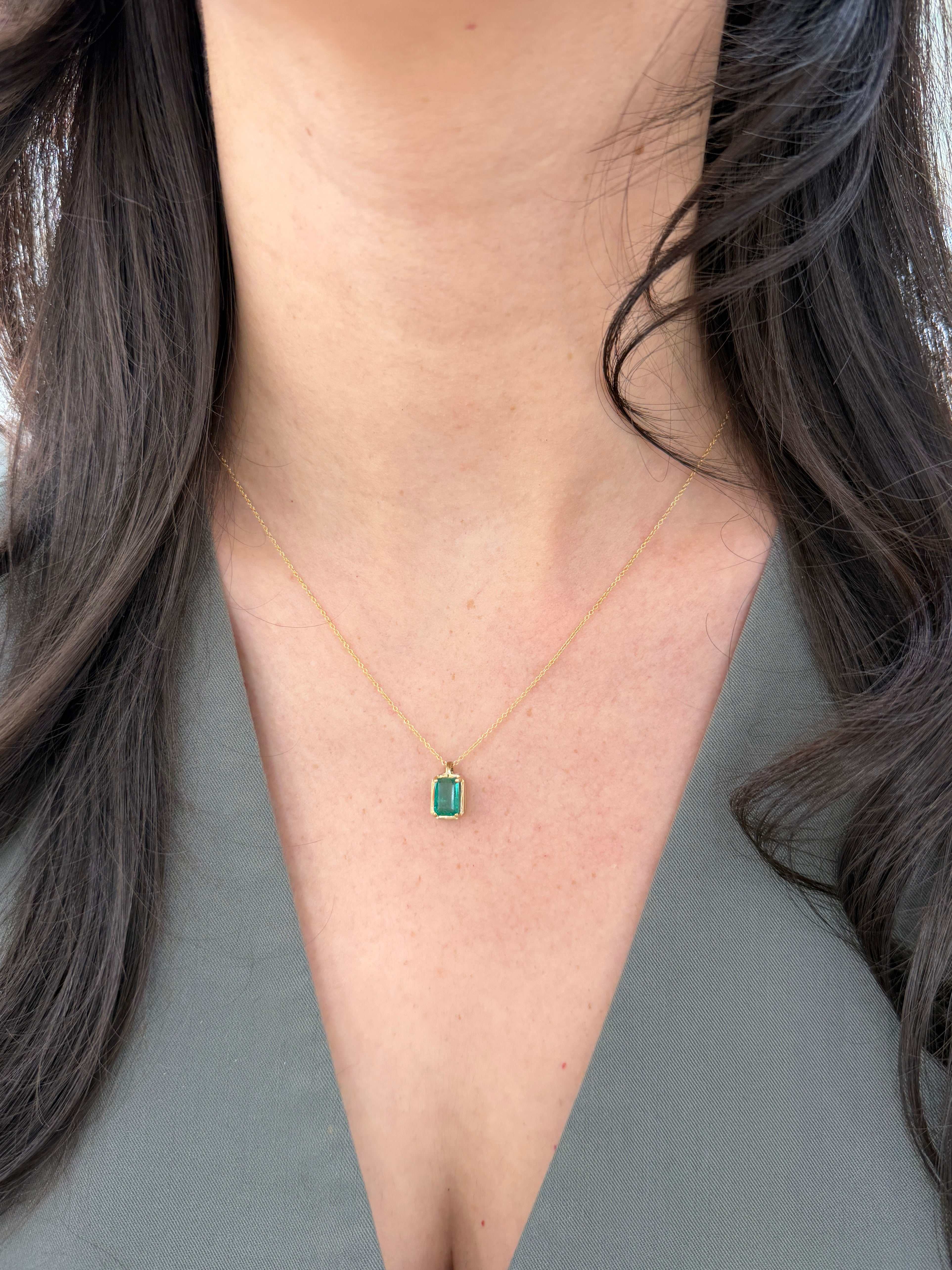 Emerald necklace featuring a 1.59 carat bluish green solitaire emerald pendant on a 14K chain by JR Colombian Emeralds.