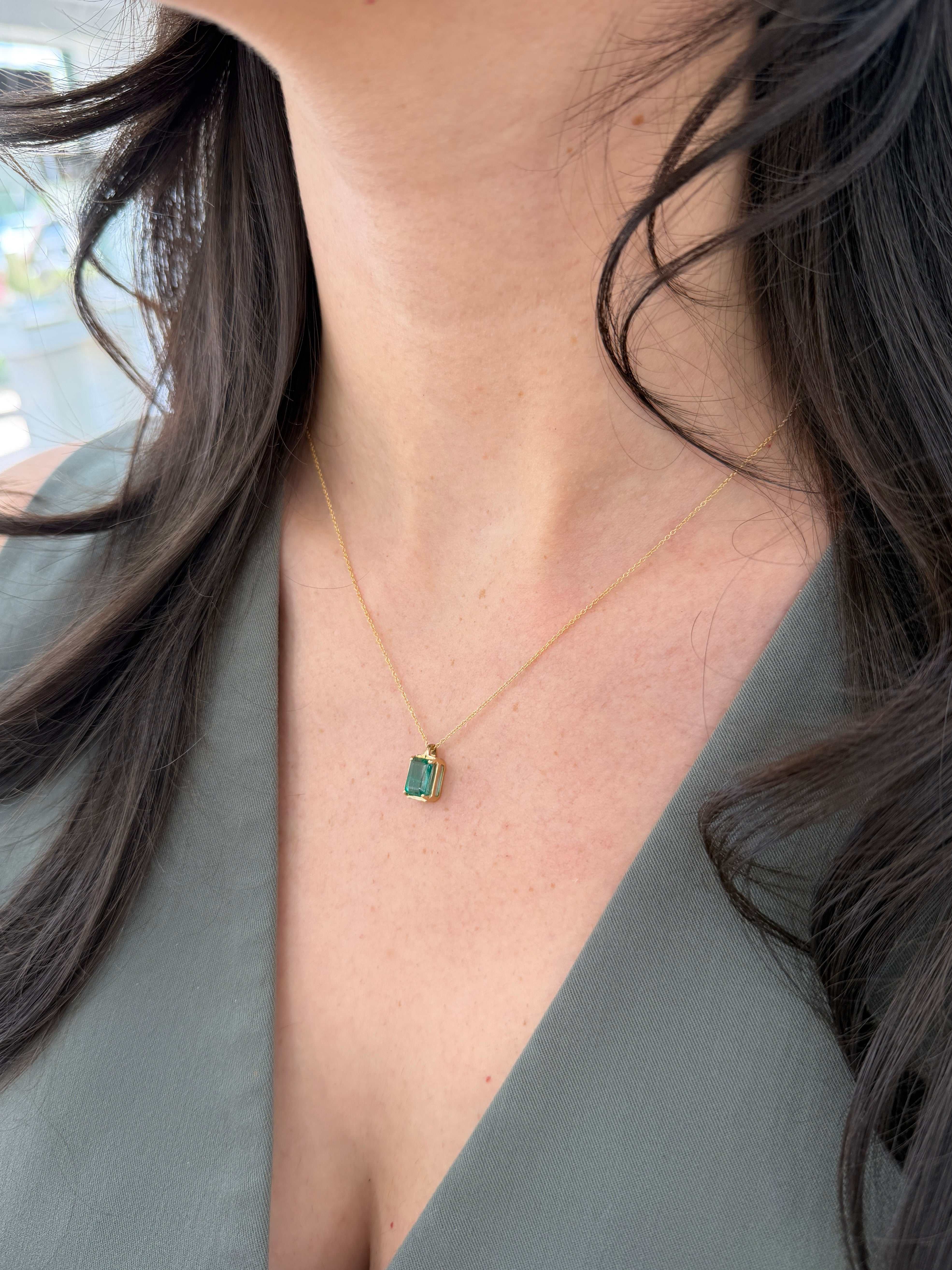 Emerald necklace featuring a 1.59 carat bluish green solitaire emerald pendant on a 14K chain, by JR Colombian Emeralds.