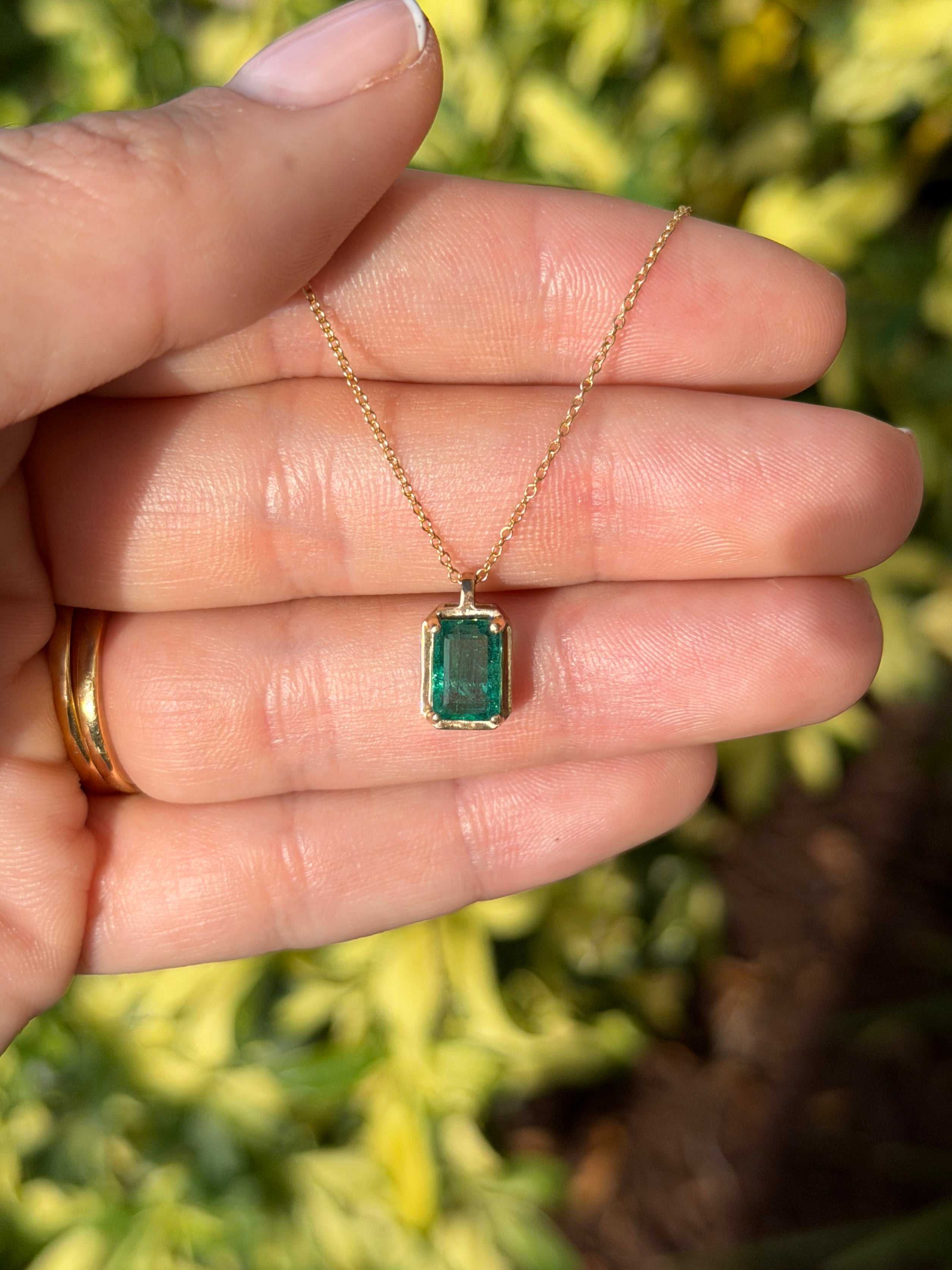 1.59 carat Bluish green solitaire emerald necklace with 14K gold setting from JR Colombian Emeralds, showcasing the elegant pendant.