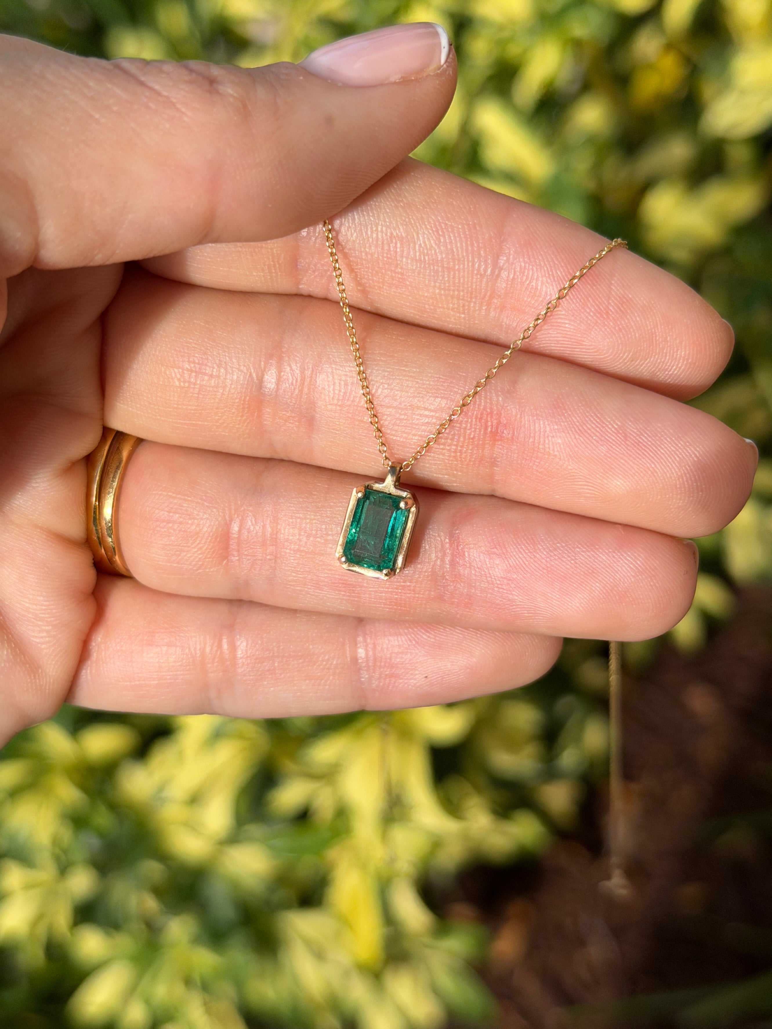 1.59 carat bluish green emerald solitaire necklace with 14K gold setting by JR Colombian Emeralds, featuring a clear, sparkling gemstone.