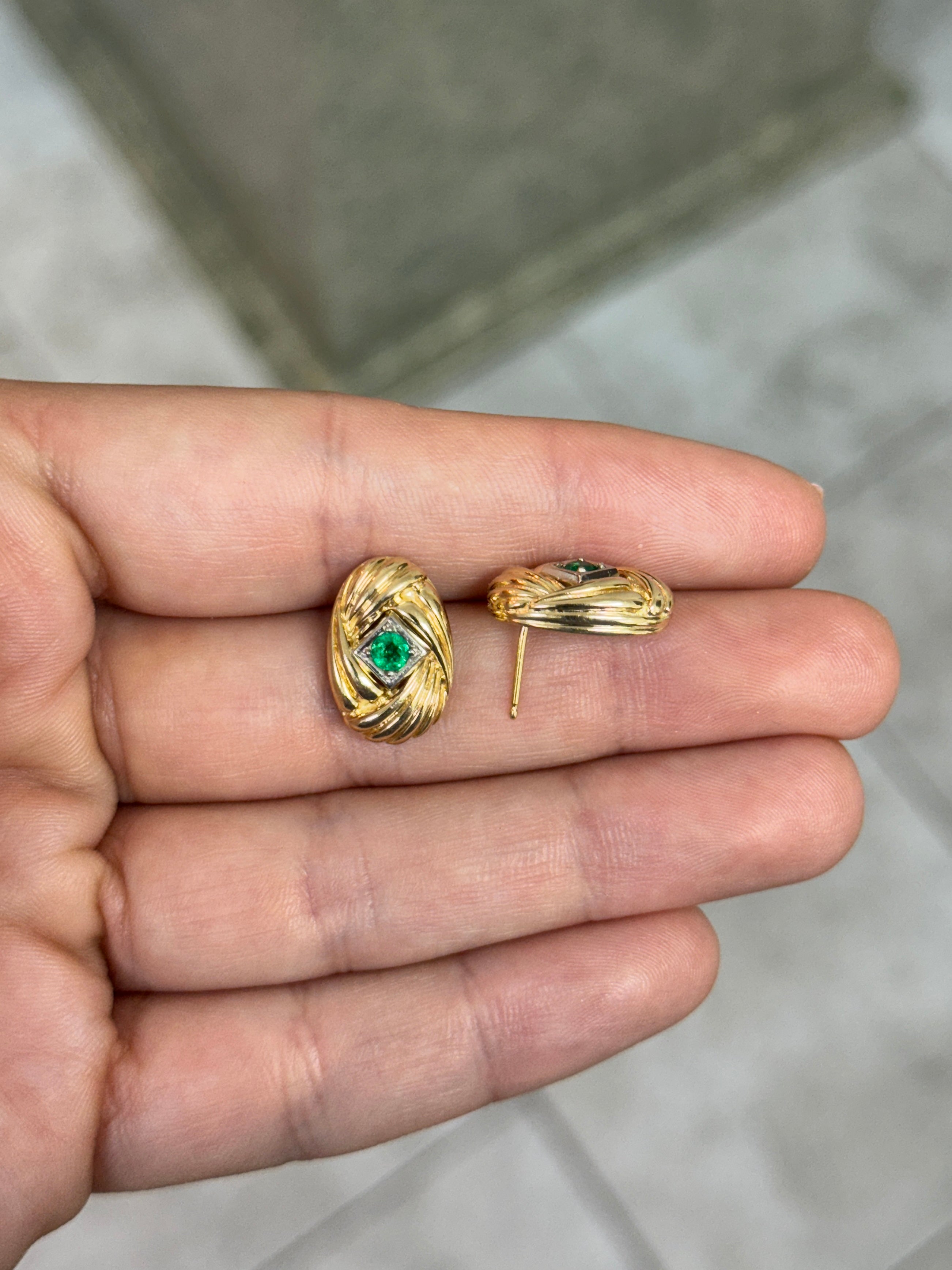 14K gold vintage Zambian emerald statement earrings with scroll and vortex design, featuring 0.70 carats of vibrant emeralds.