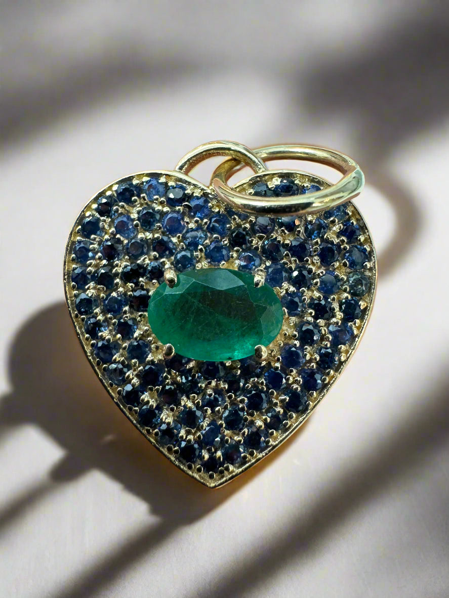 14K gold heart charm with oval emerald and blue sapphire pave setting