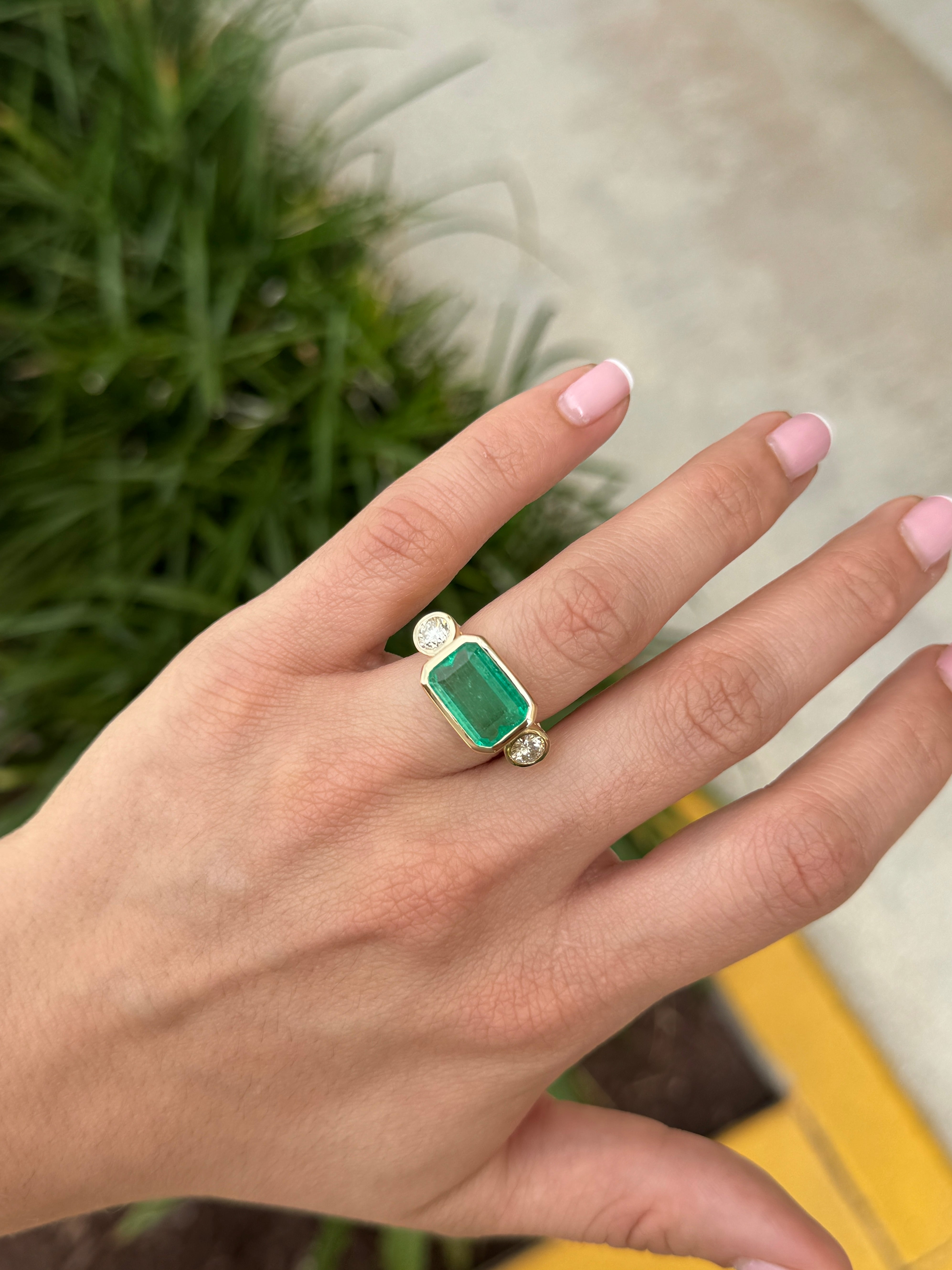 6.30 Carat Colombian Emerald East West Bezel Ring With Round Diamonds In 18K Gold Full Finger Coverage