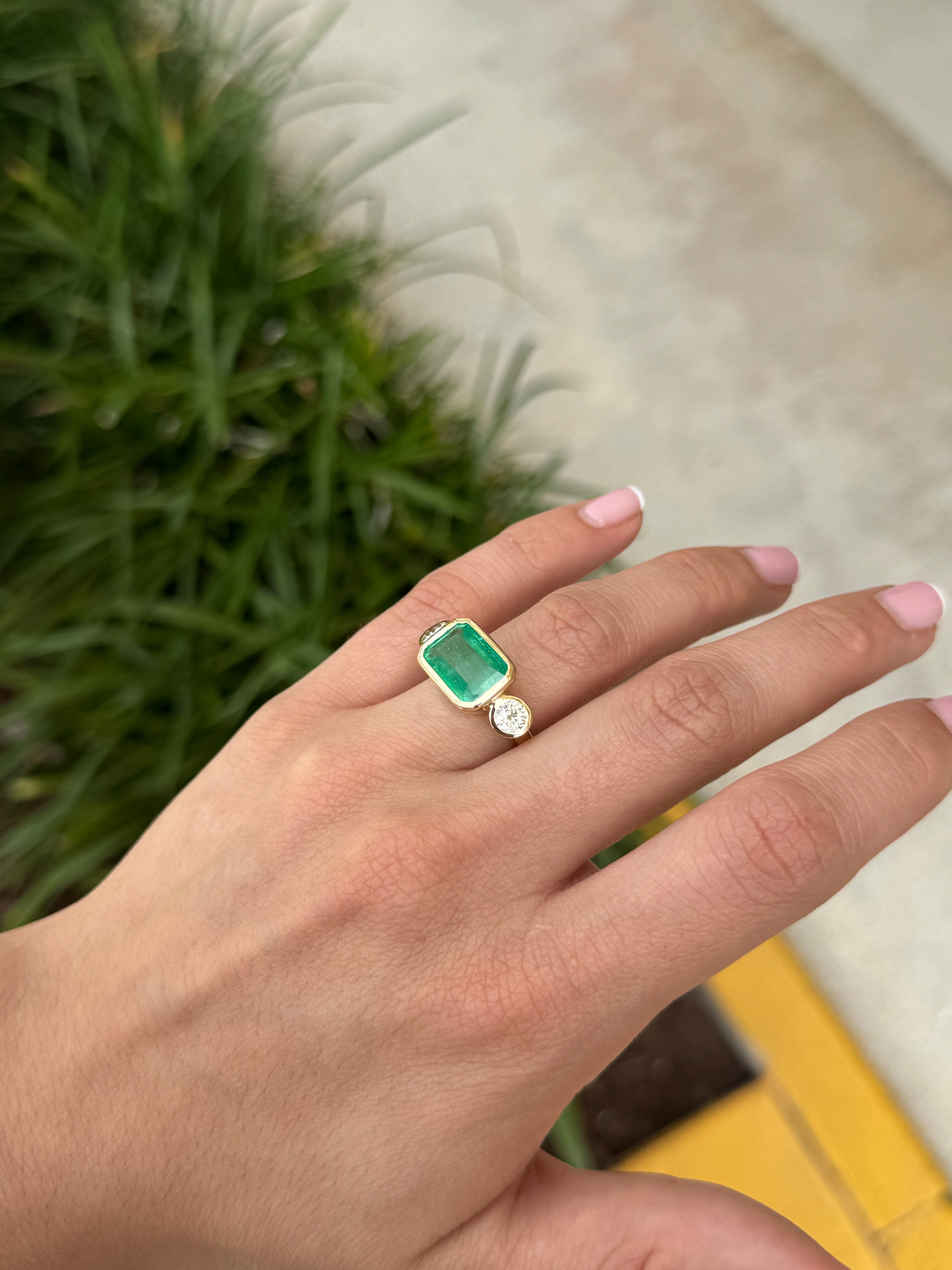 6.30 Carat Colombian Emerald East West Bezel Ring With Round Diamonds In 18K Gold Full Finger Coverage