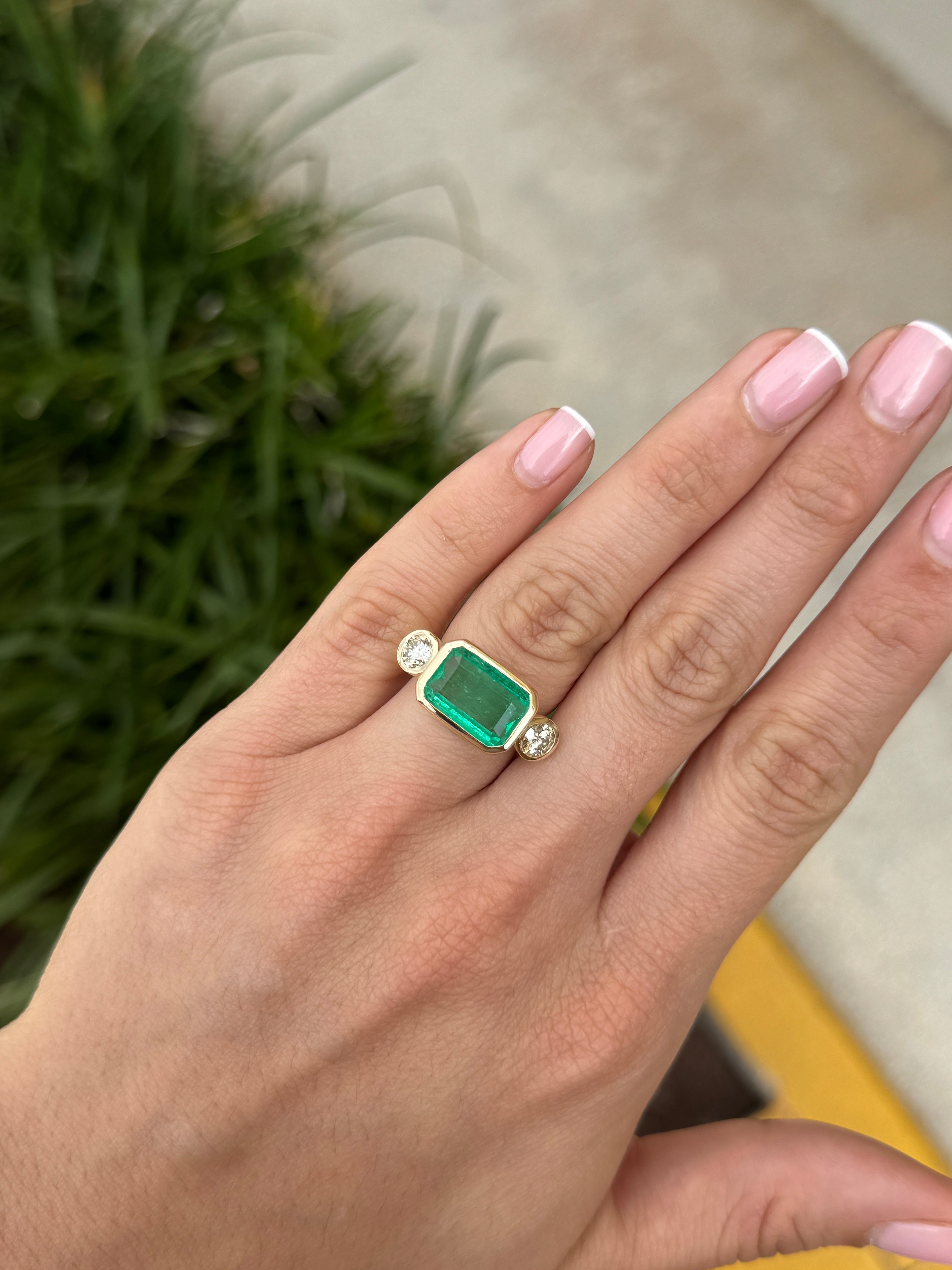 6.30 Carat Colombian Emerald East West Bezel Ring With Round Diamonds In 18K Gold Full Finger Coverage