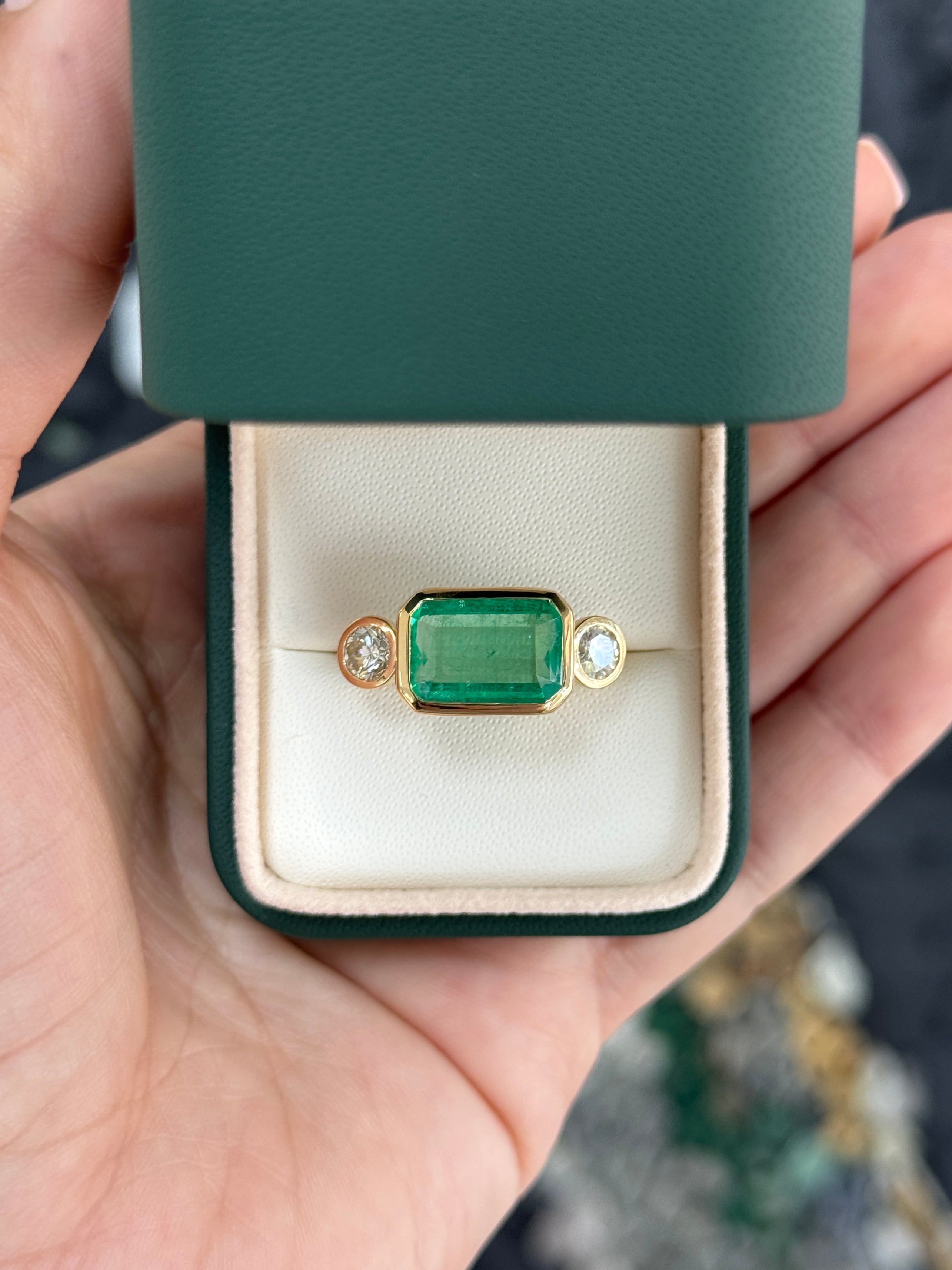 6.30 Carat Colombian Emerald East West Bezel Ring With Round Diamonds In 18K Gold Full Finger Coverage