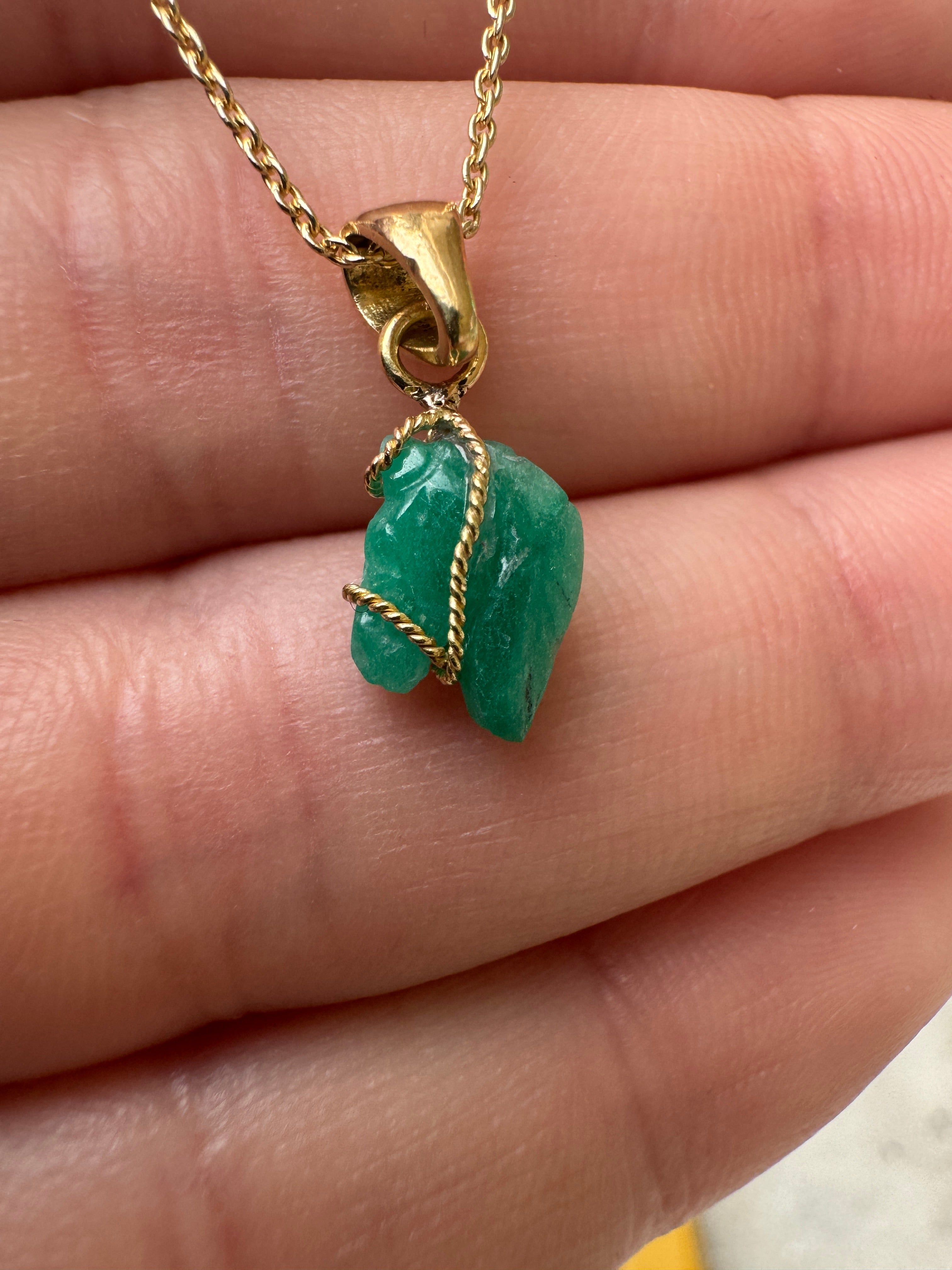 18K gold necklace featuring a 1.40 carat Chinese New Year horse-shaped Colombian emerald pendant.