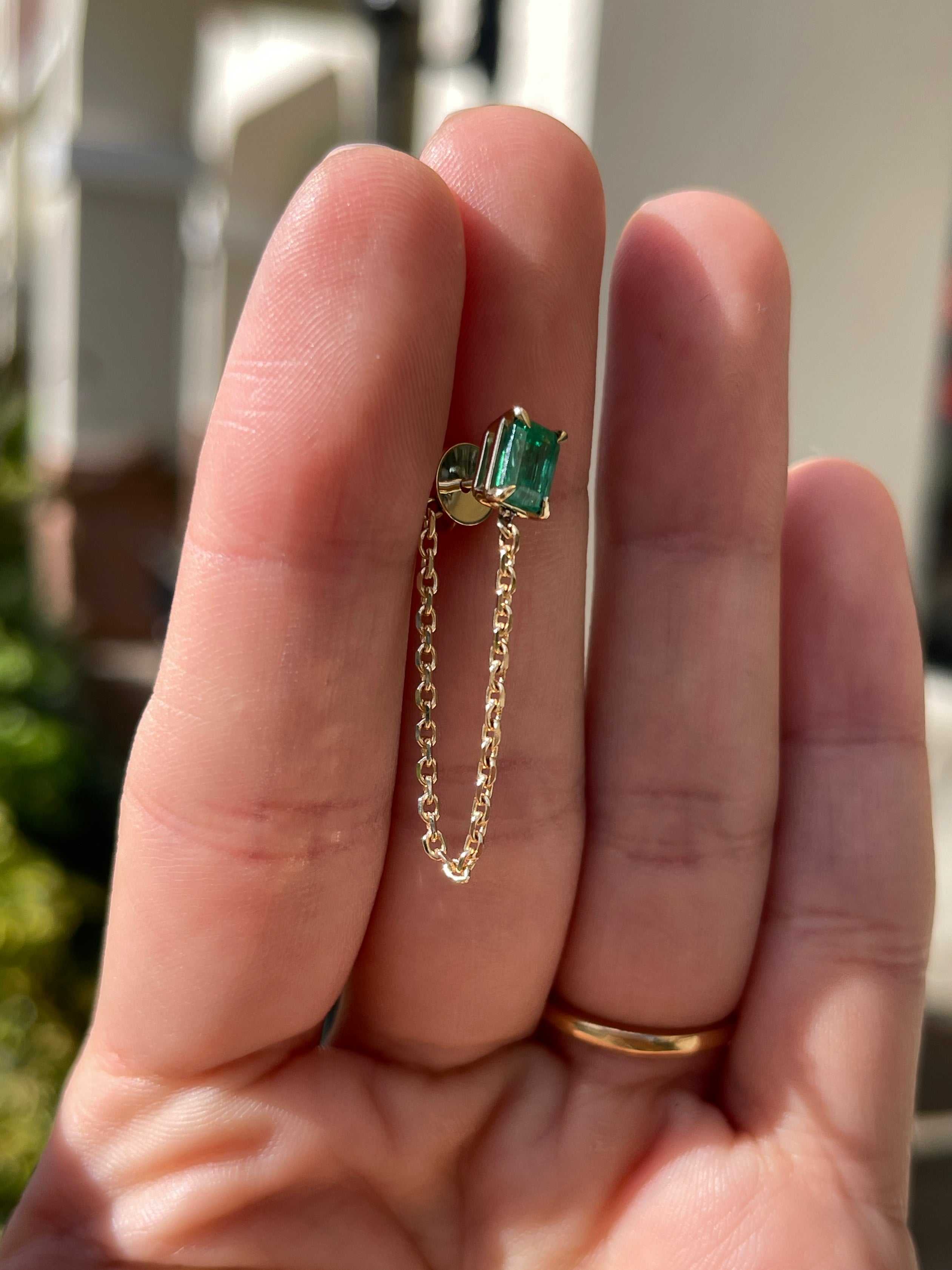 14K yellow gold single emerald cut emerald stud earring with delicate chain dangle