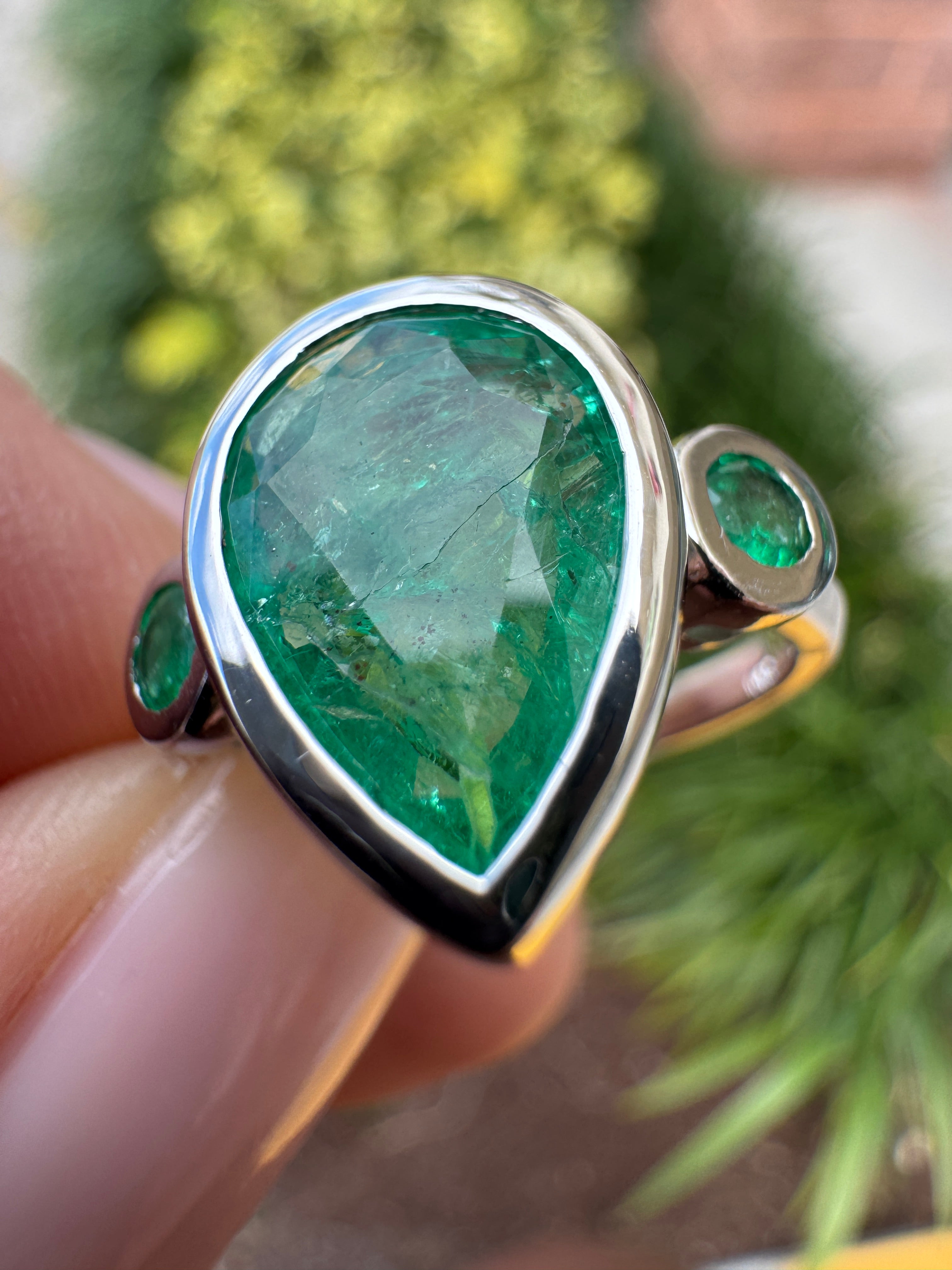 14K white gold three stone engagement ring with pear and round cut emeralds, featuring 2.30tcw from JR Colombian Emeralds.