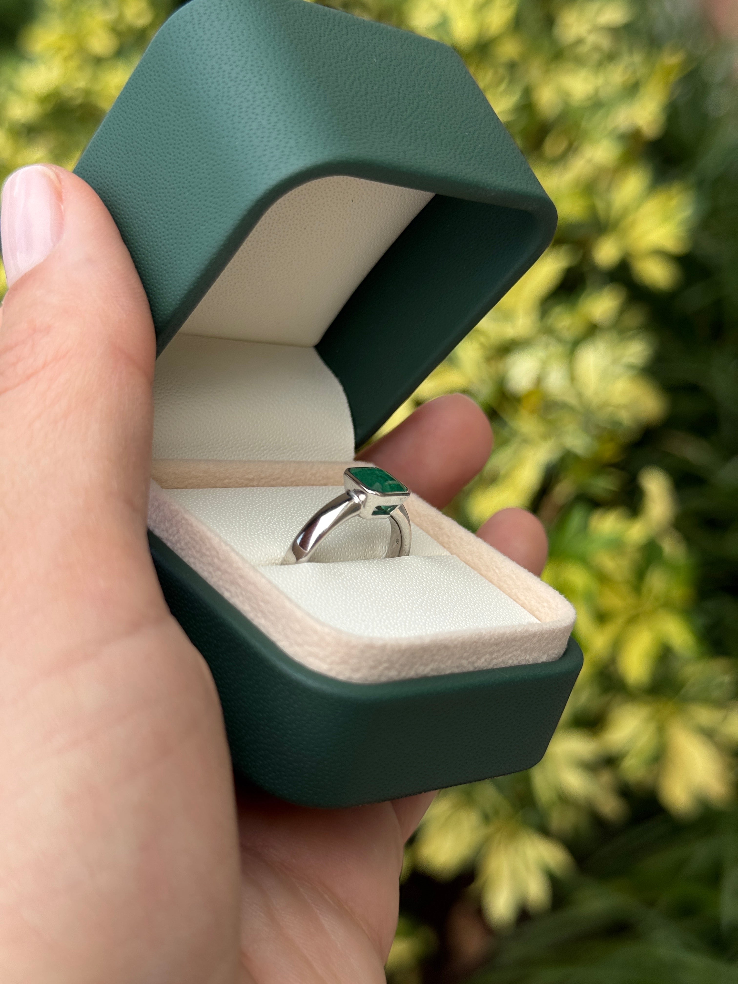 1.32 carat bezel set Asscher cut emerald white gold solitaire ring by JR Colombian Emeralds featuring a 14K design.