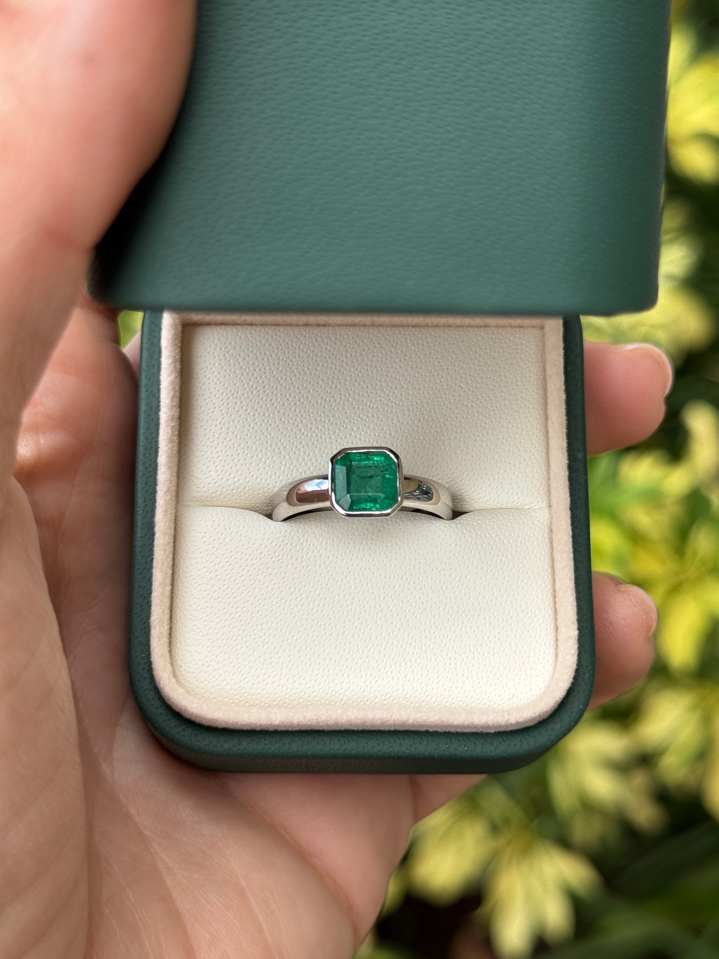 Asscher cut emerald solitaire ring with 1.32 carats in 14K white gold bezel setting by JR Colombian Emeralds.