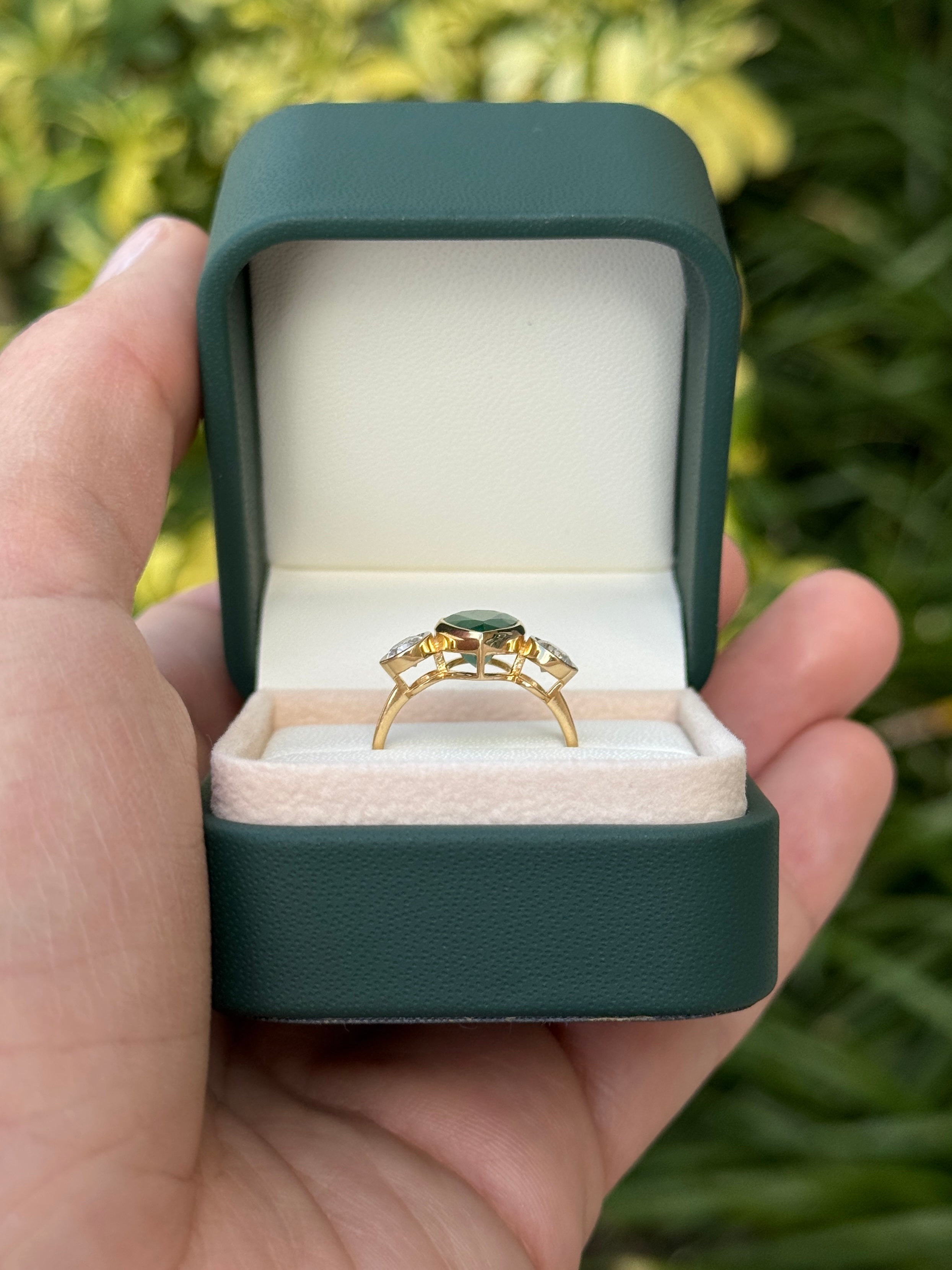 Two and 91-carat pear-shaped emerald three-stone ring with round diamond accents in 18K yellow gold by JR Colombian Emeralds.