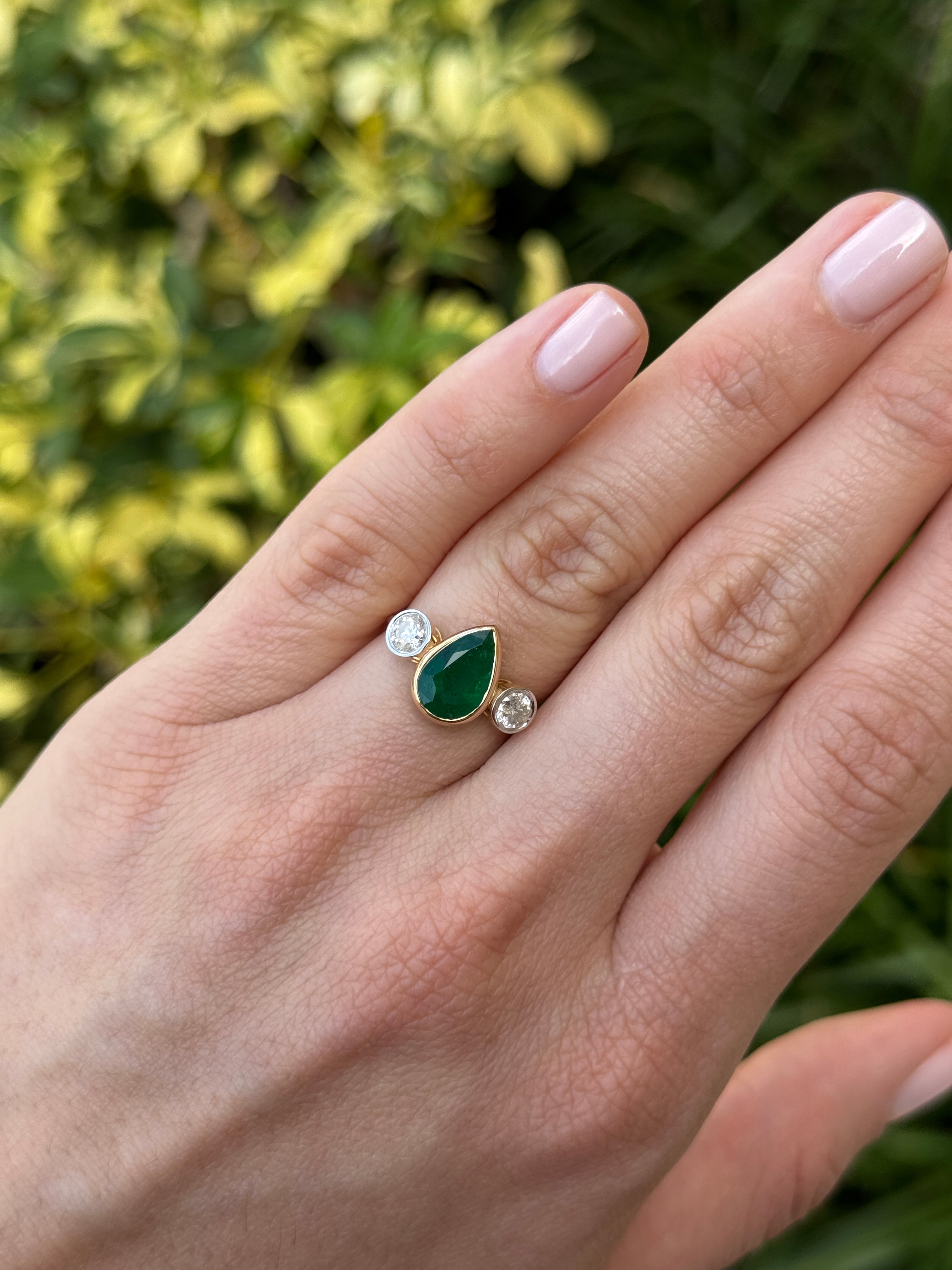 Two and 91 carat pear-shaped emerald three-stone ring with round diamond accents in 18K yellow gold by JR Colombian Emeralds.