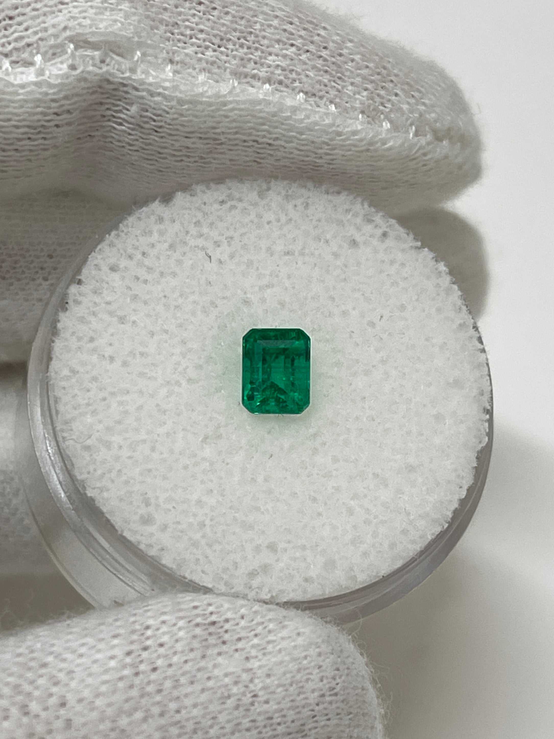 0.62 carat emerald cut Colombian emerald with vivid Muzo green color.