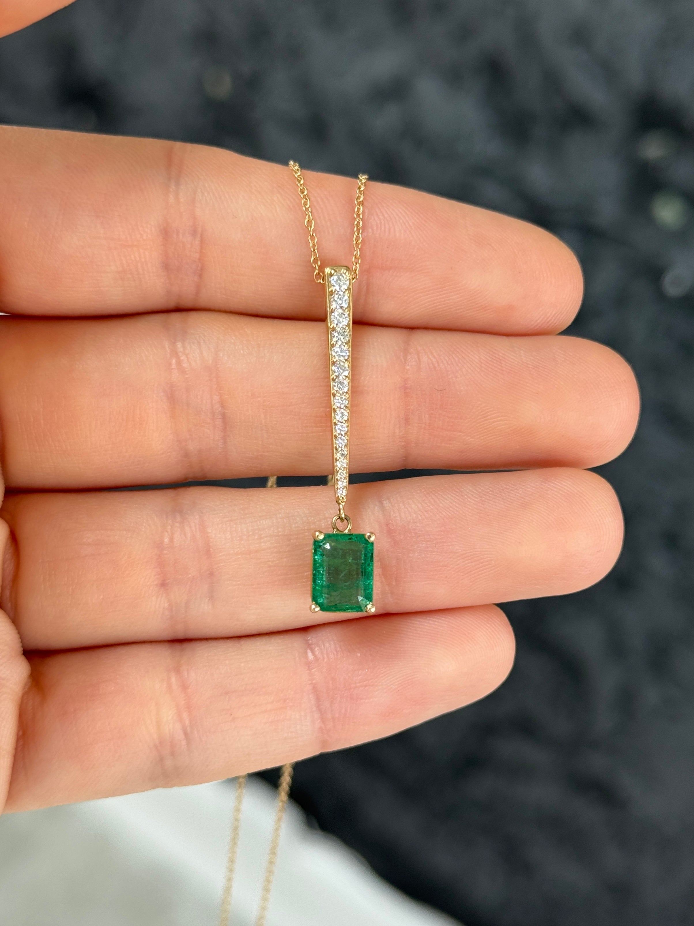 14K gold emerald and diamond V-drop pendant necklace featuring a 2.68tcw natural emerald cut emerald and diamond accents.