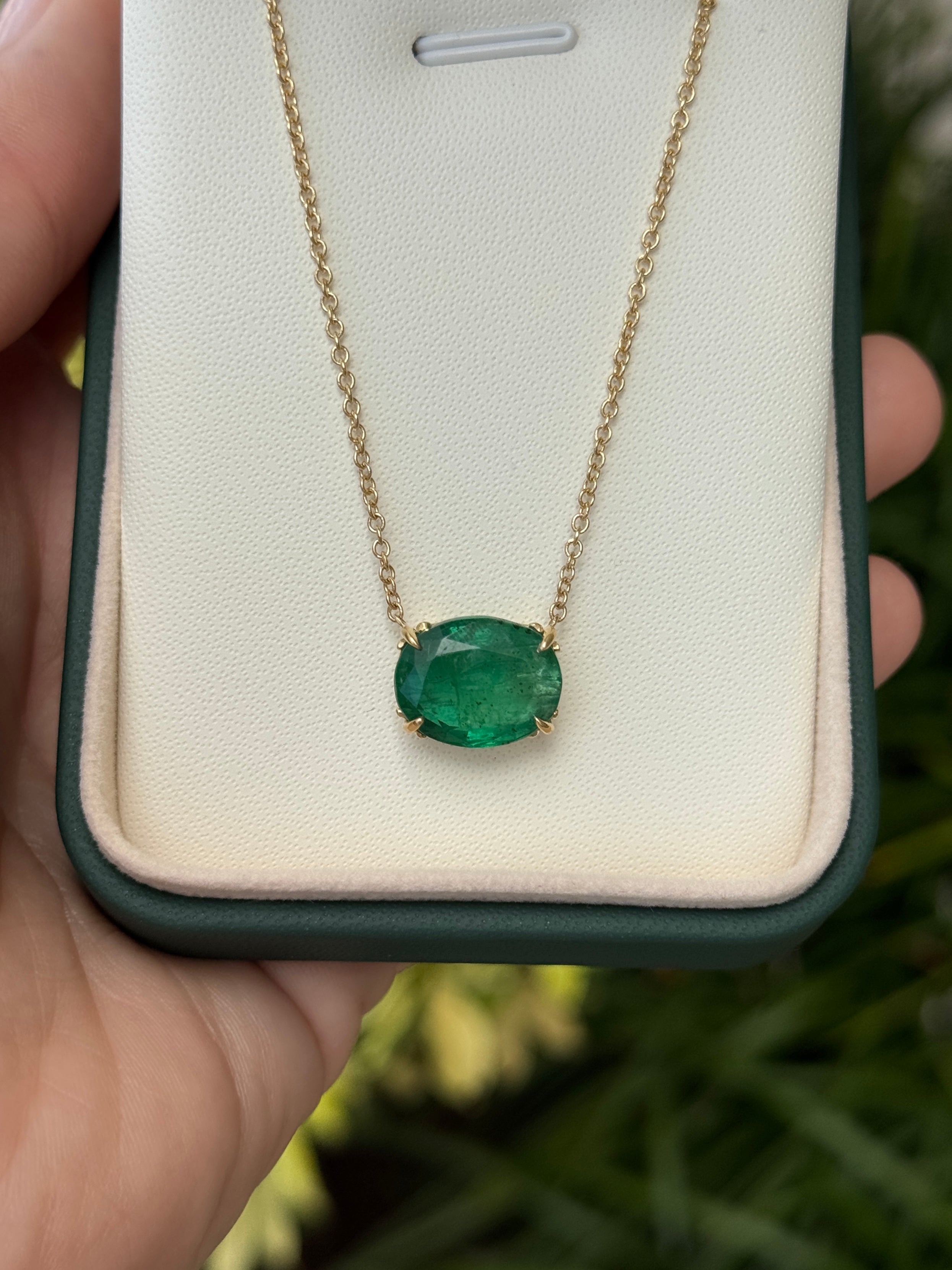 6.80ct 18K gold emerald necklace featuring oval-shaped emeralds and Fleur de Lis station design by JR Colombian Emeralds
