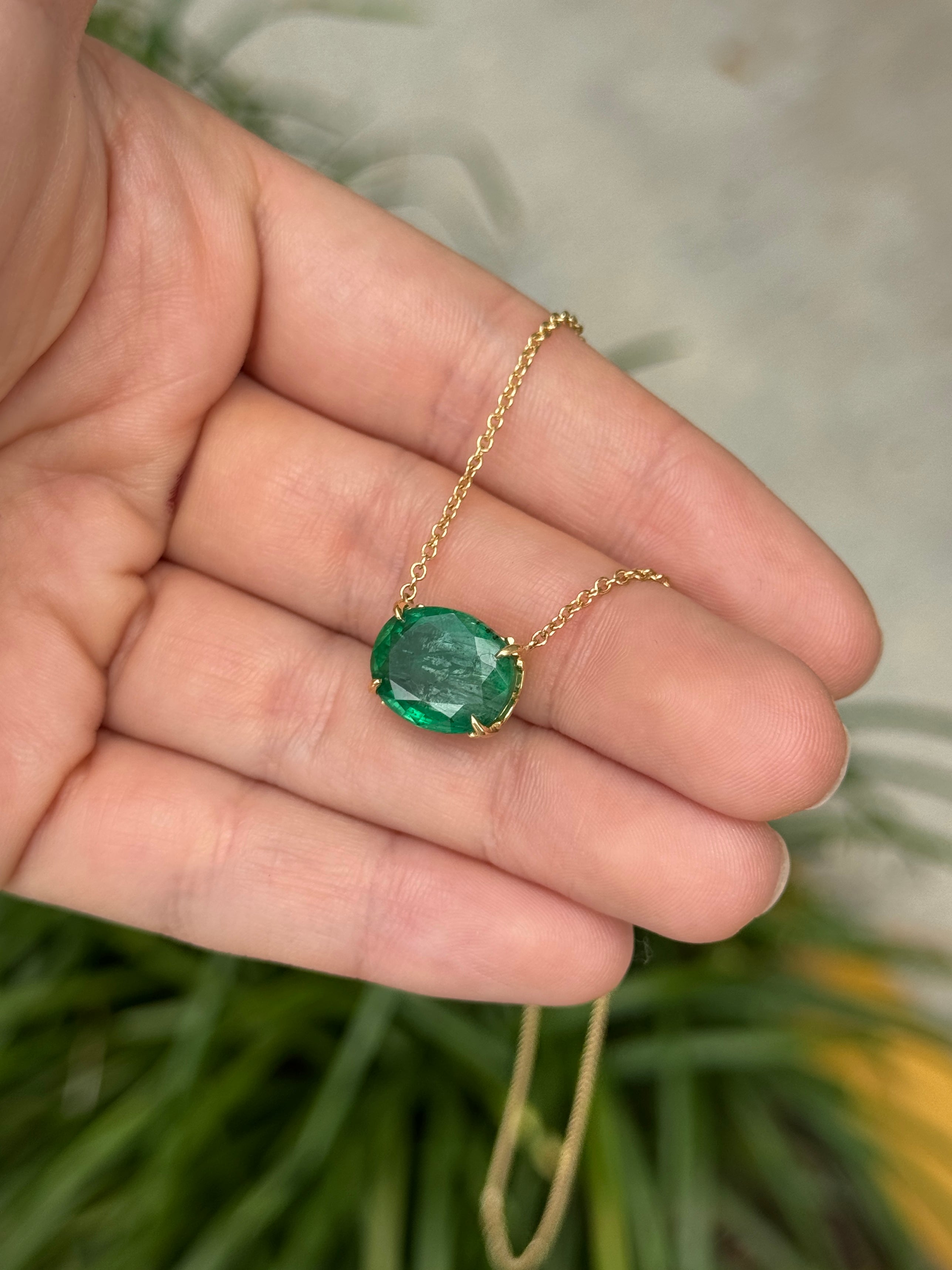 18K gold emerald necklace featuring a 6.80ct oval Colombian emerald with fleur de lis station design by JR Colombian Emeralds.