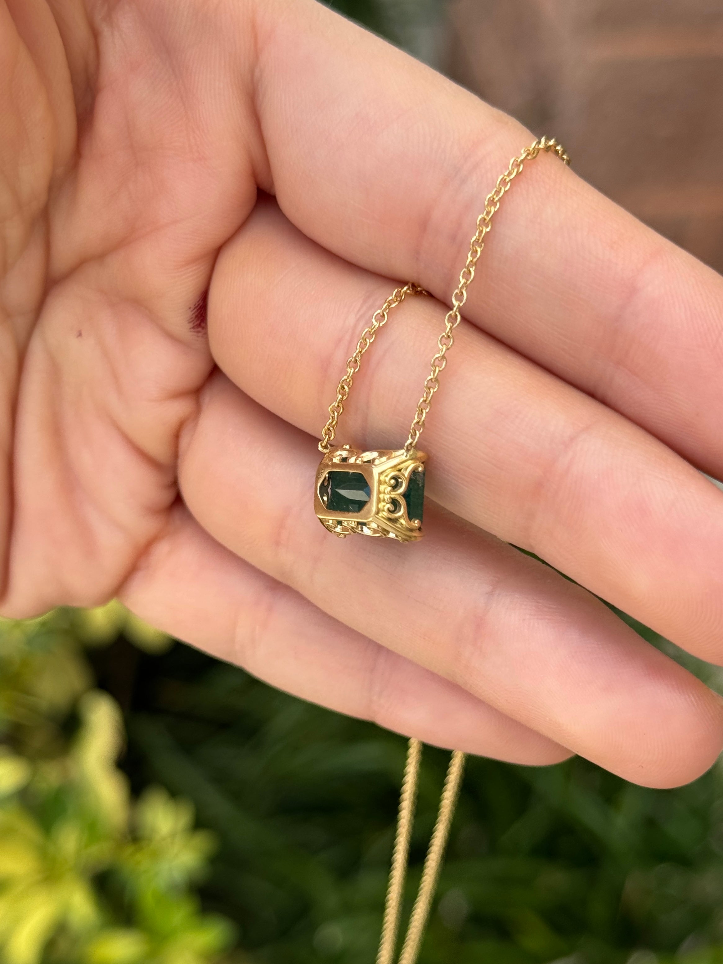 18K gold emerald solitaire necklace with east-west station, floral fleur de lis design, featuring a 5.70ct natural Colombian emerald.