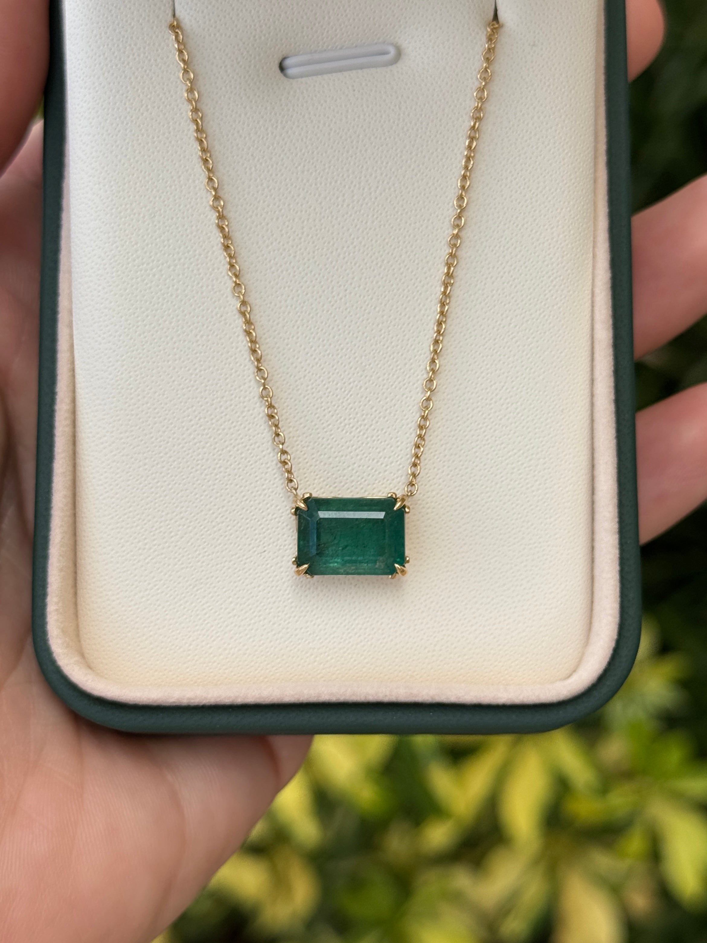 18K gold Emerald Solitaire Necklace with east-west stationary emeralds and fleur de lis design, by JR Colombian Emeralds
