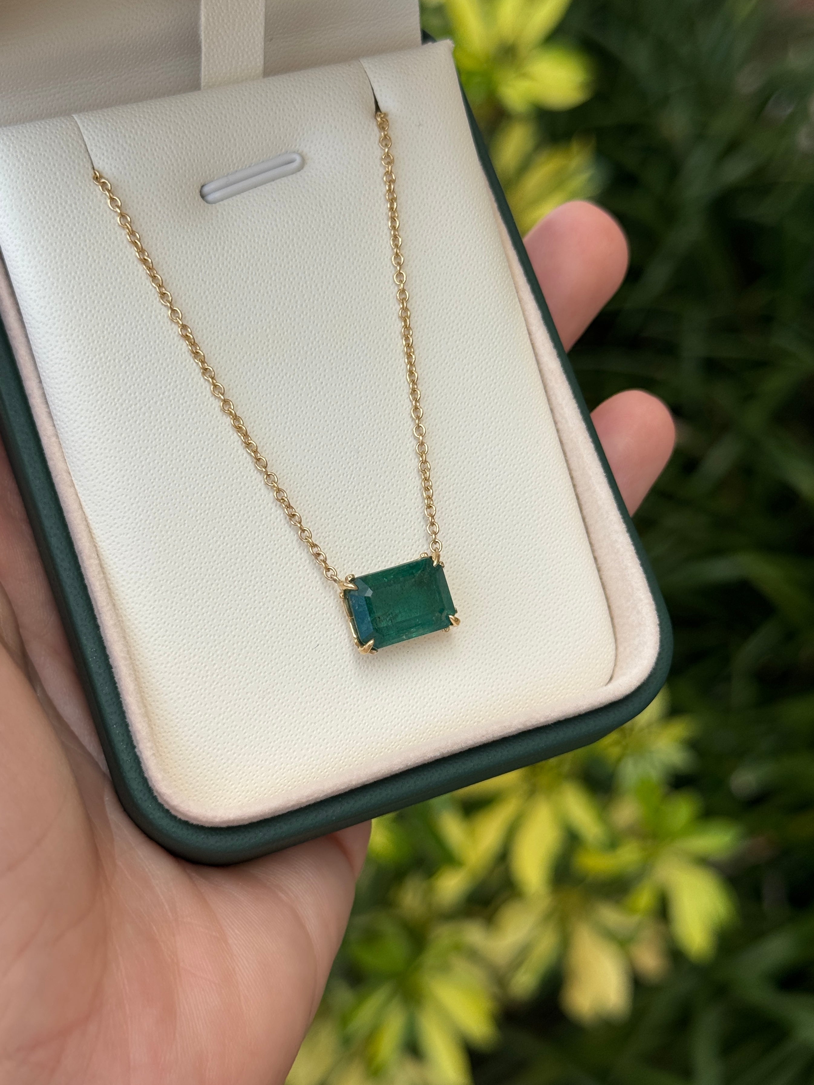 East to west stationary emerald solitaire necklace with fleur de lis design, 5.70ct 18K gold from JR Colombian Emeralds.