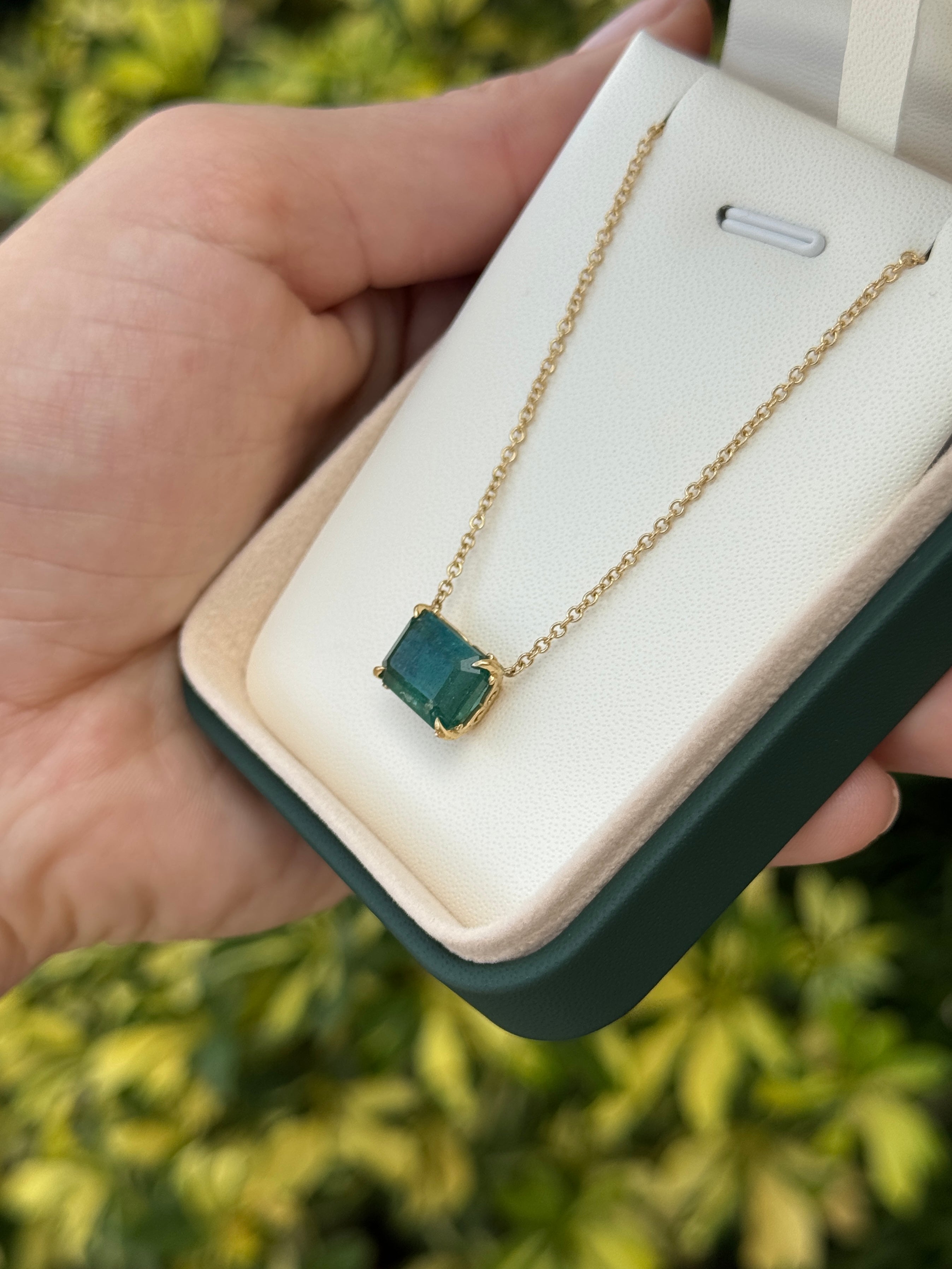 East to West emerald solitaire necklace with floral fleur de lis design, 5.70ct 18K gold by JR Colombian Emeralds.