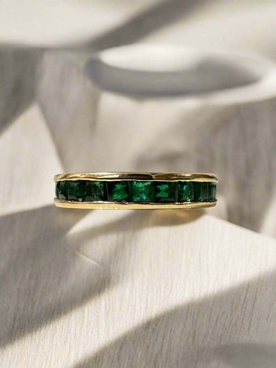 14K yellow gold eternity band with 2.02tcw princess cut natural emeralds in channel setting