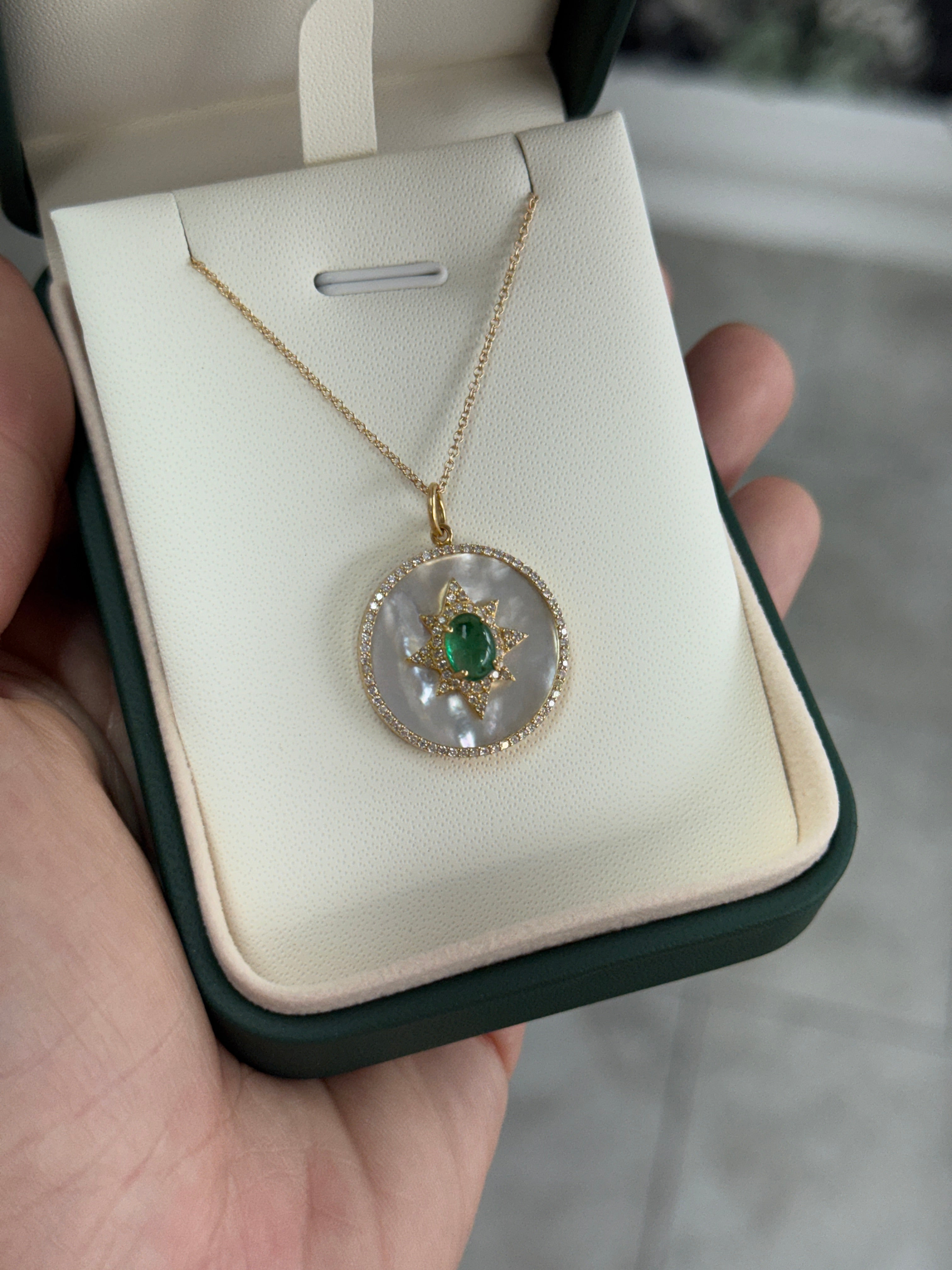 14K gold starburst medallion featuring an 8.89tcw emerald cabochon, mother of pearl, and diamond halo by JR Colombian Emeralds.