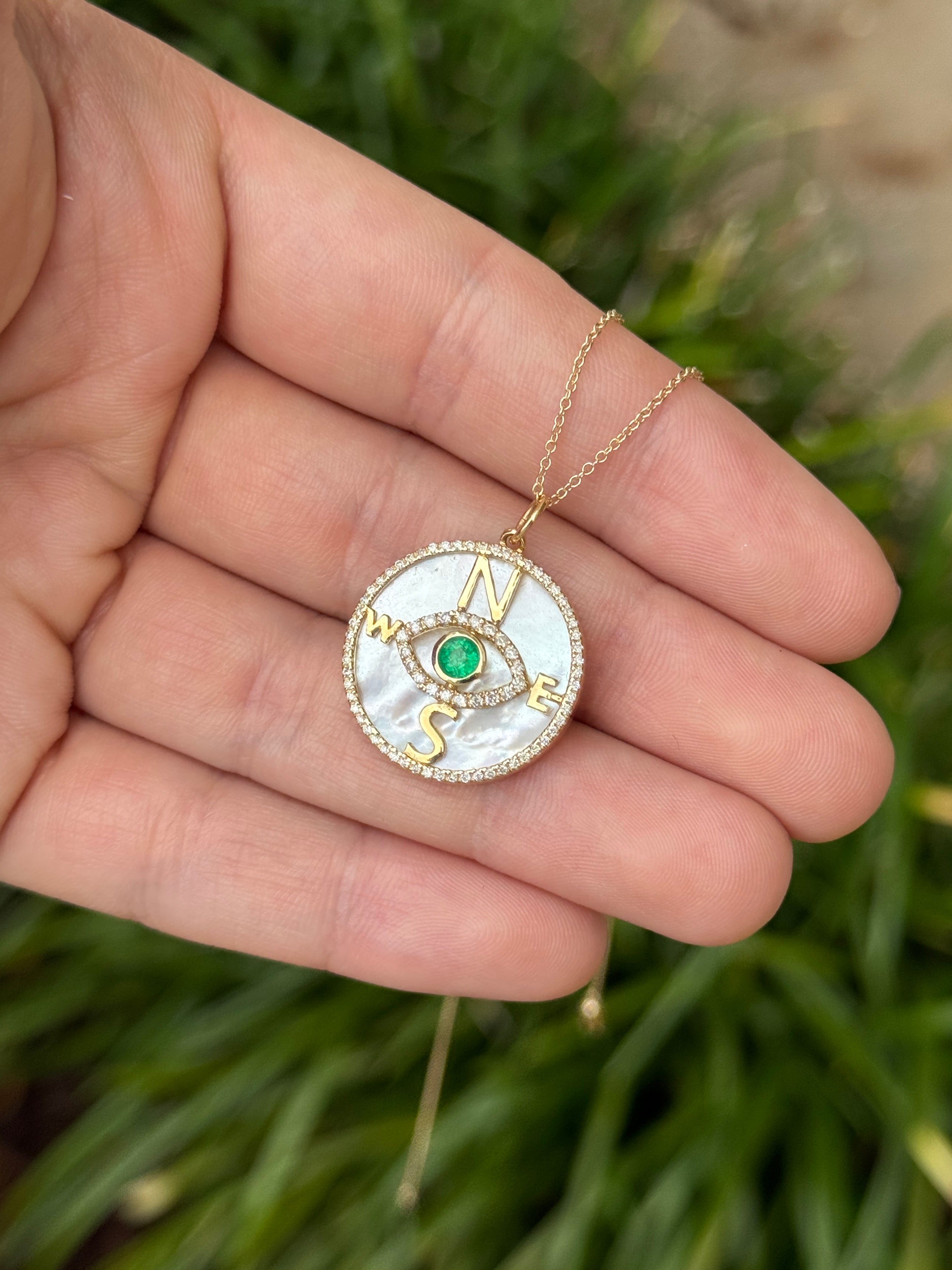 14K gold compass evil eye pendant necklace with round emeralds, diamonds, and mother of pearl from JR Colombian Emeralds.
