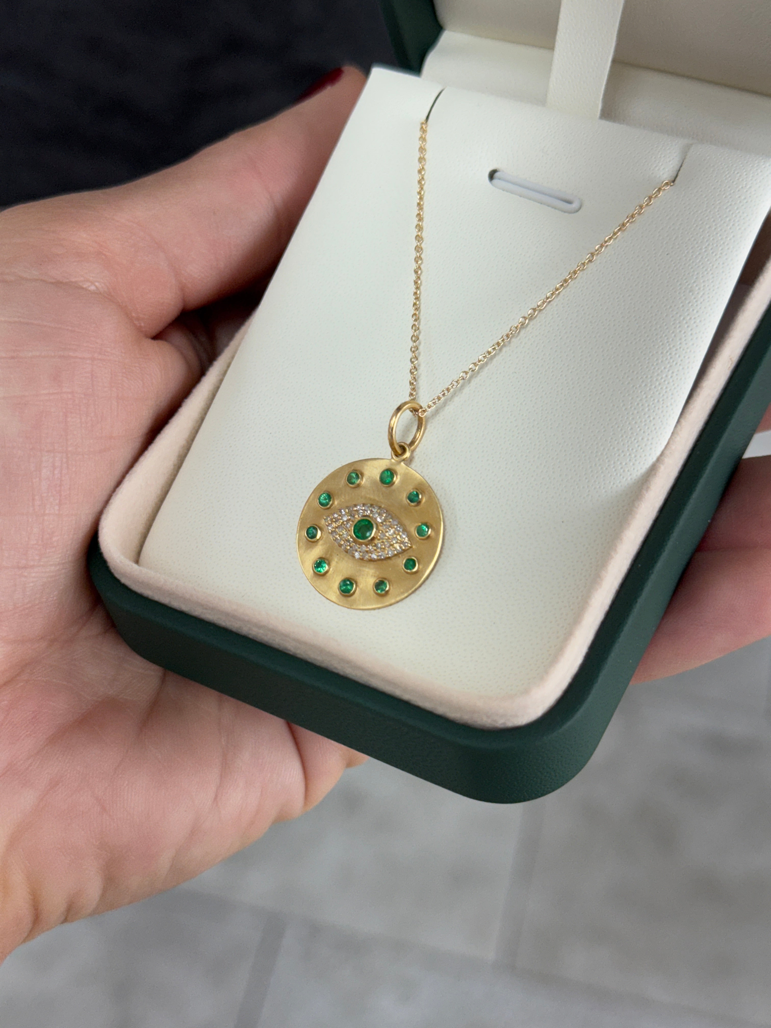 14K gold evil eye pendant with natural emerald and diamond accents, featuring a protective charm from JR Colombian Emeralds.