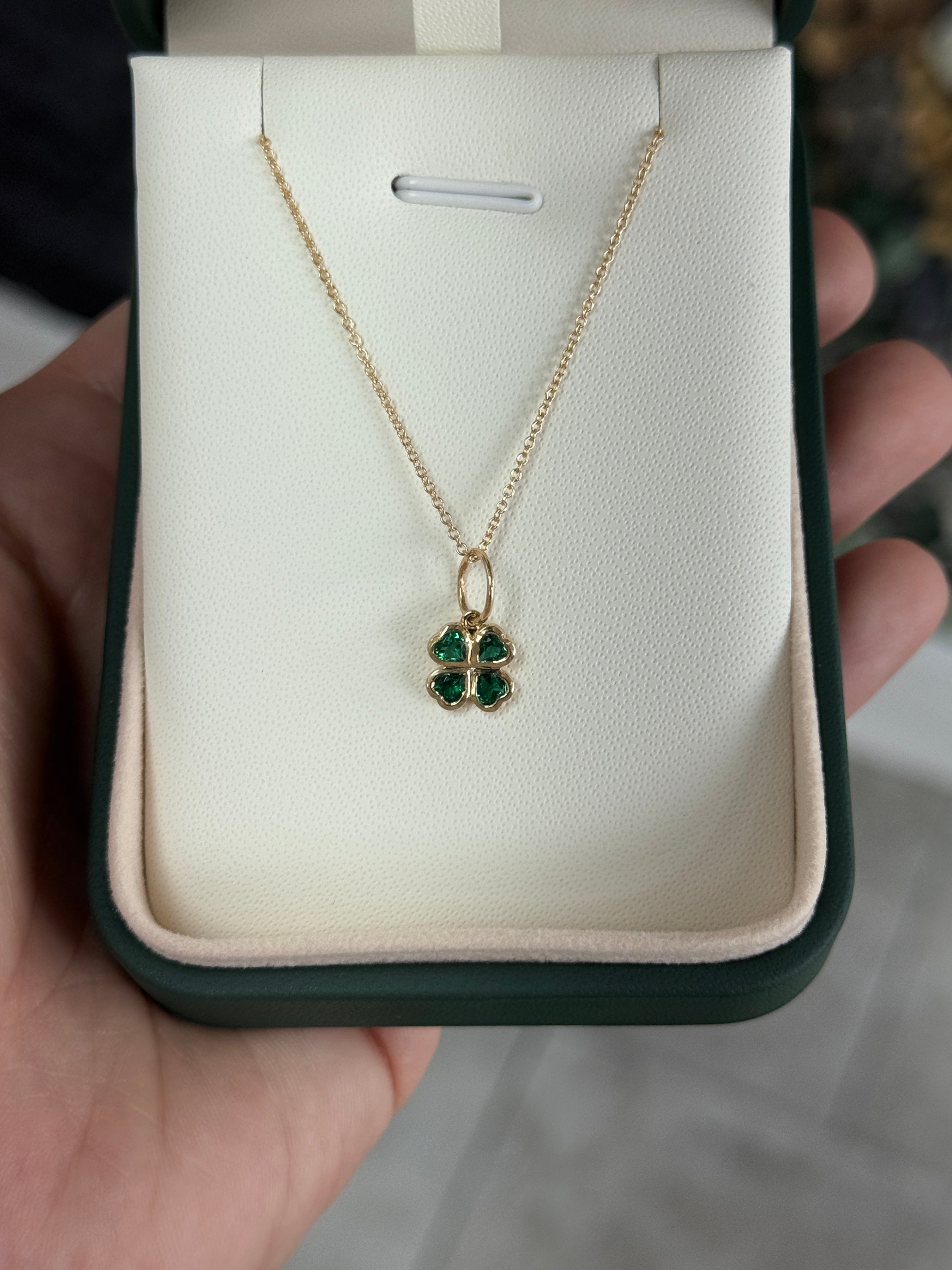 14K gold heart cut emerald clover charm pendant with 0.44 tcw from JR Colombian Emeralds, showcasing a detailed jewelry design.