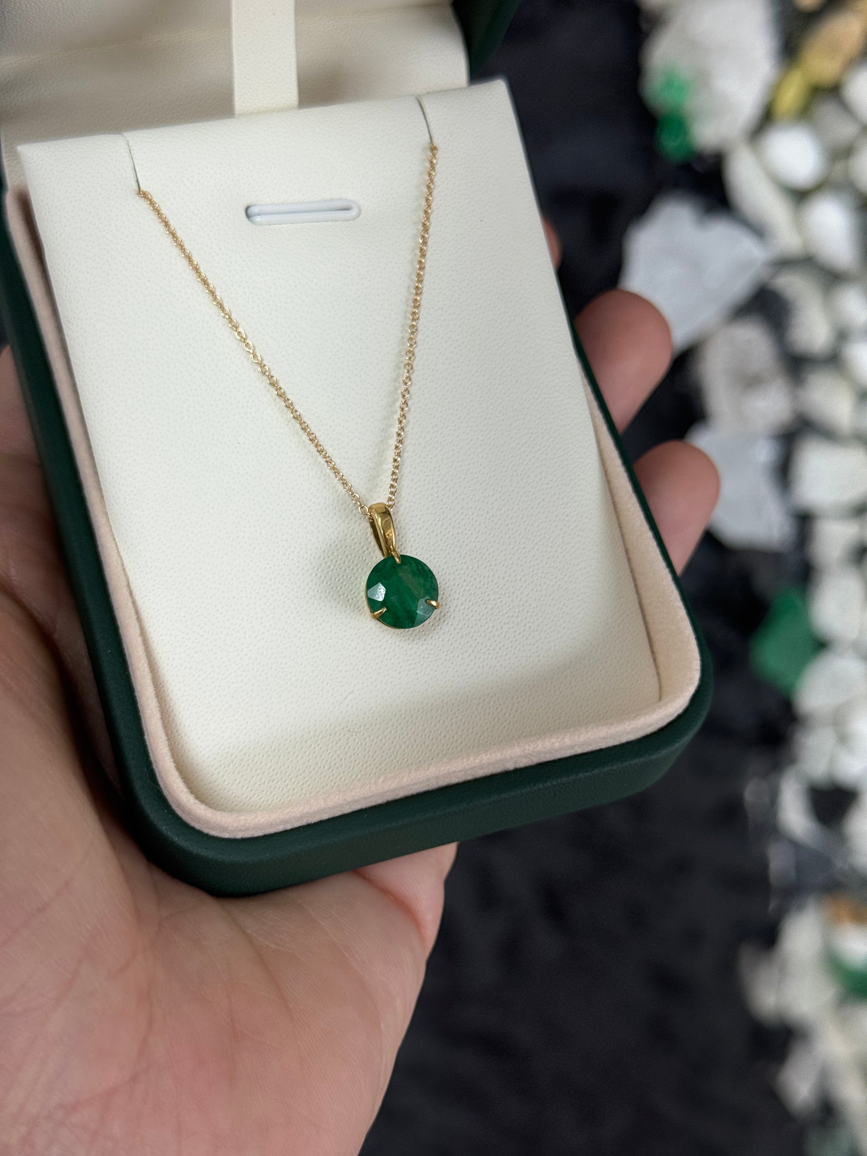 14K gold emerald solitaire necklace with a 1.66ct round emerald in a three-prong setting, from JR Colombian Emeralds.