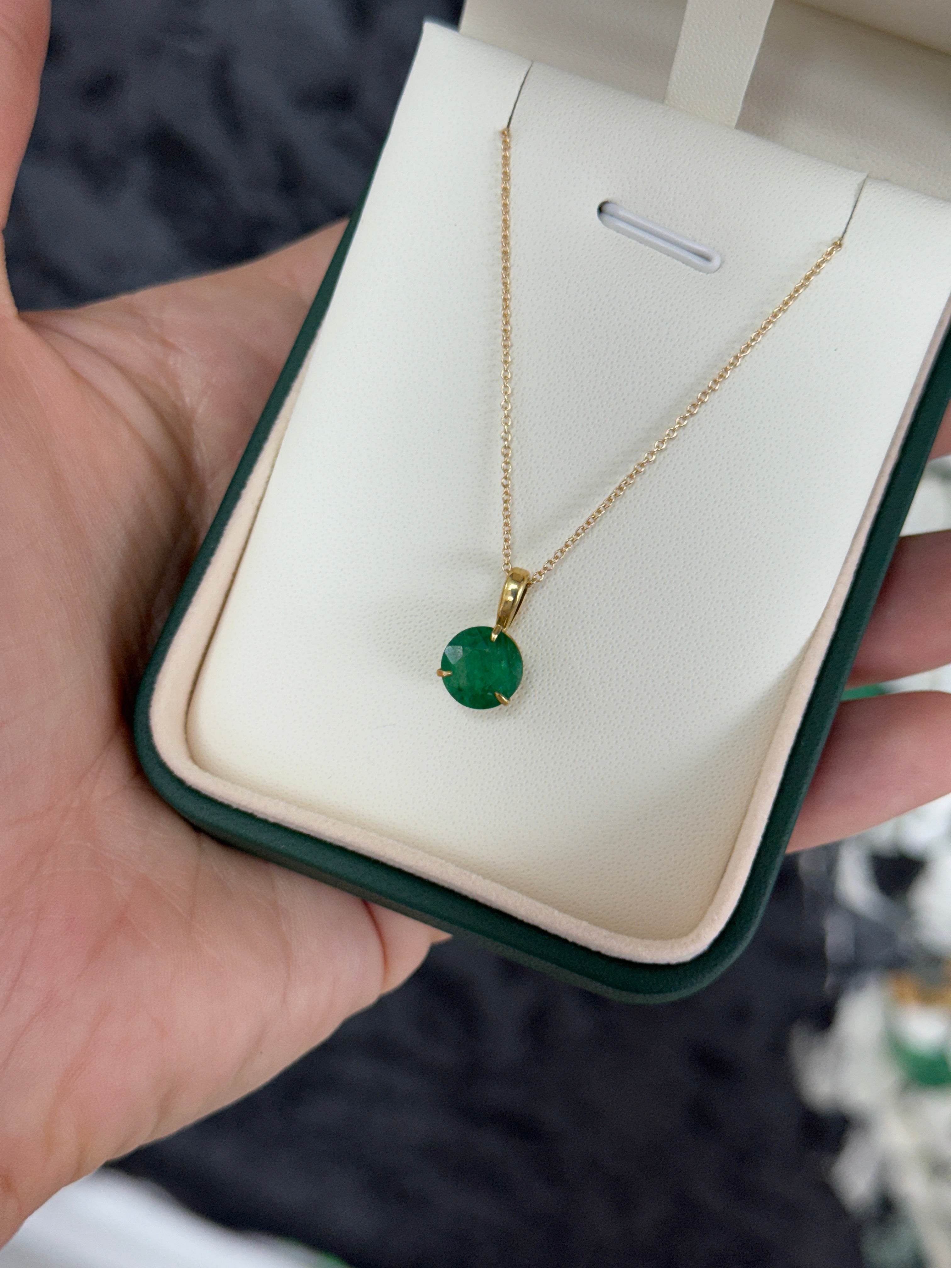 14K gold emerald solitaire necklace featuring a 1.66ct round emerald in a three-prong setting, from JR Colombian Emeralds.