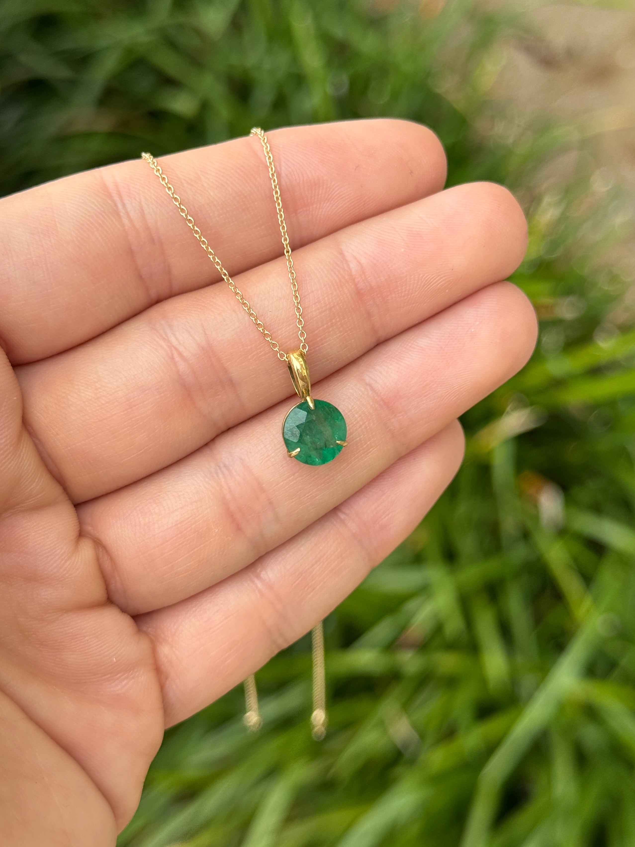 14K gold emerald solitaire necklace with a 1.66ct round emerald in a three-prong setting, from JR Colombian Emeralds.