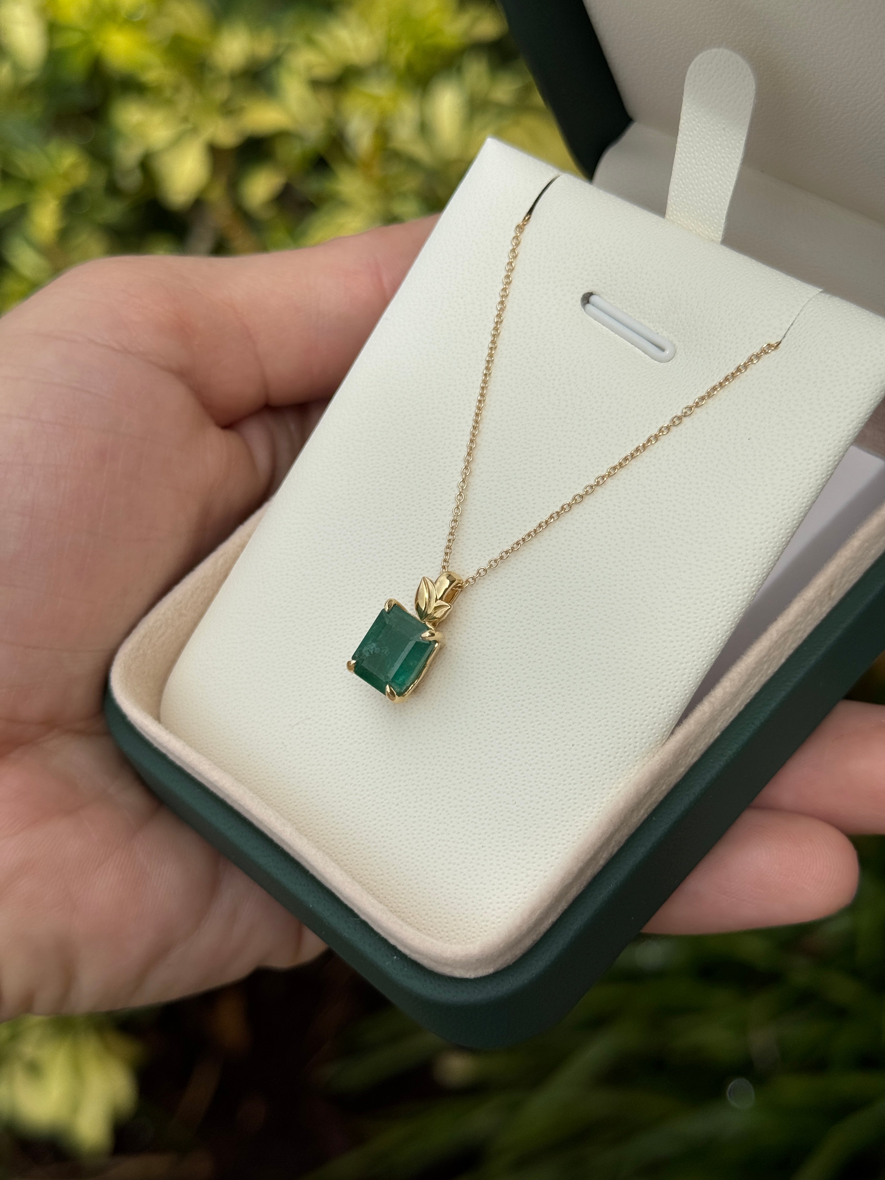 Emerald cut emerald pendant with leaf design and 14K gold bail, natural-inspired emerald necklace by JR Colombian Emeralds.