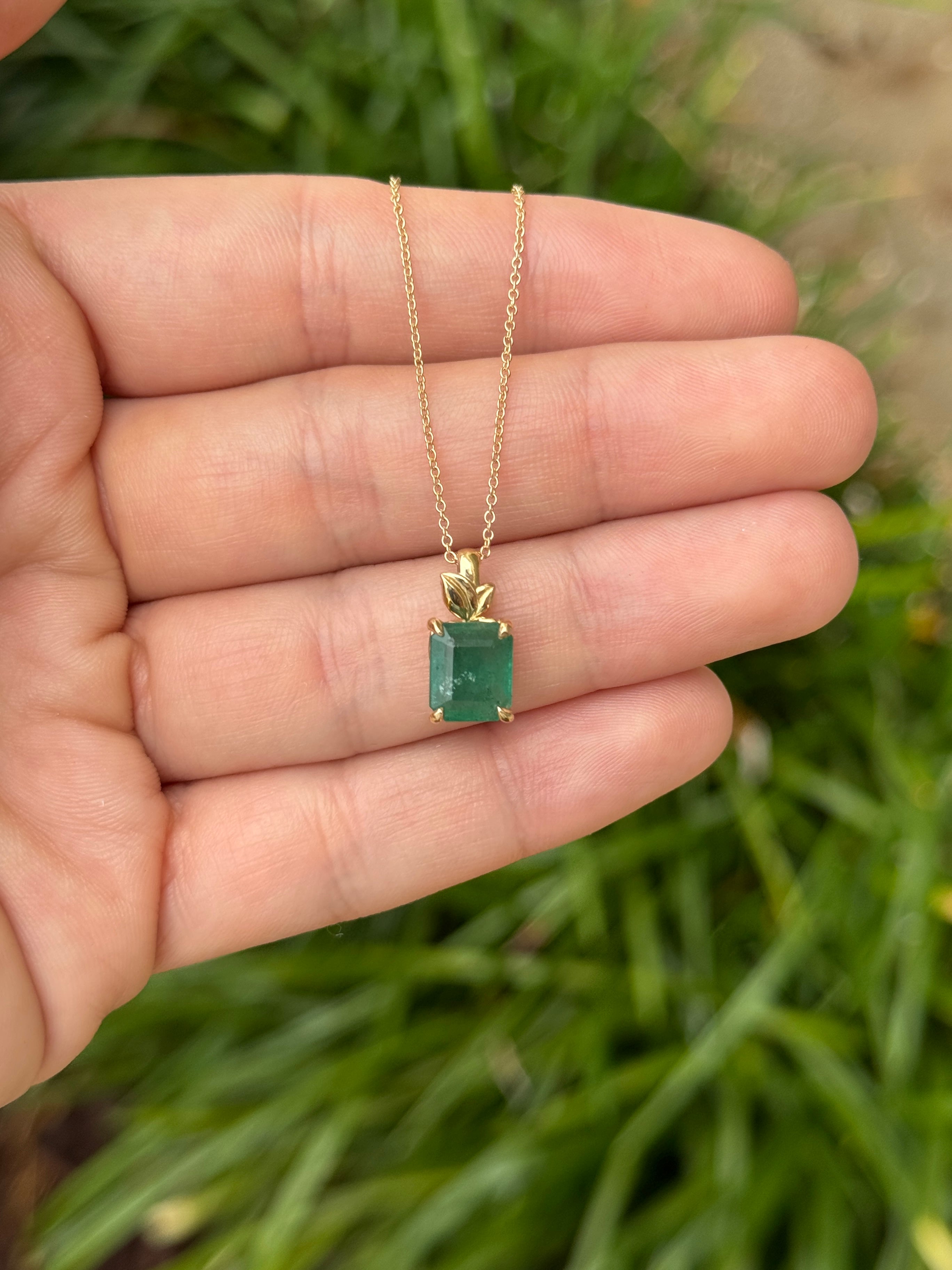 Emerald cut emerald pendant with leaf design on 14K gold chain, natural-inspired jewelry by JR Colombian Emeralds.