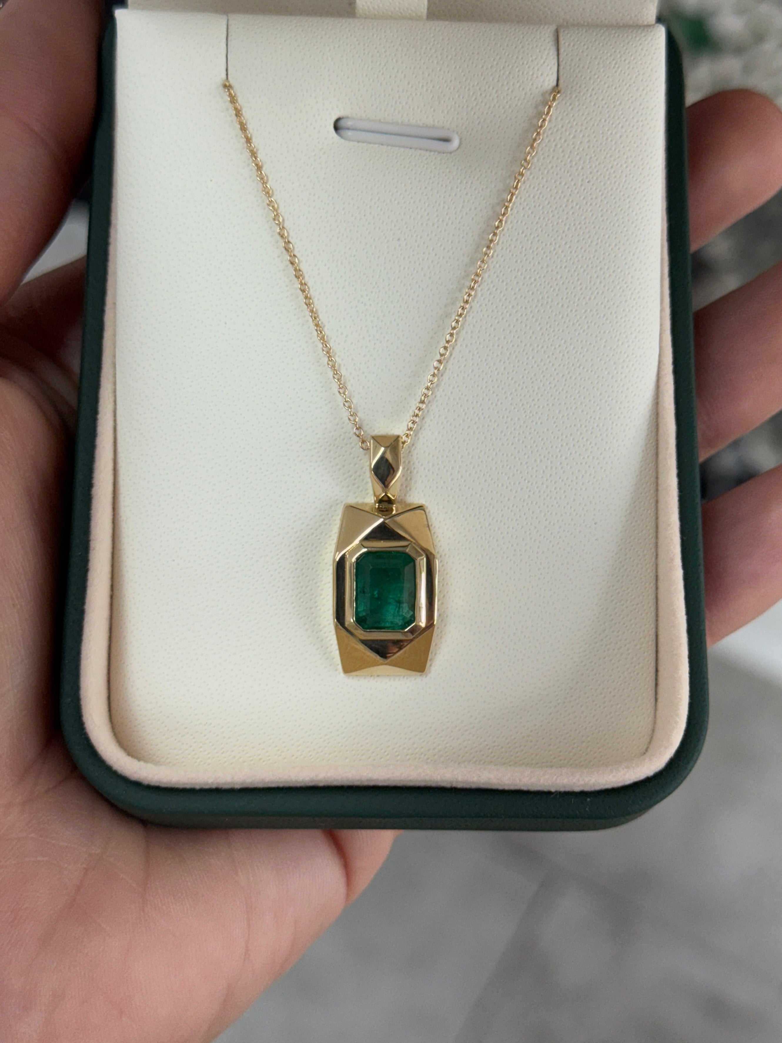 14K gold emerald dog tag pendant with 2.35 carats of JR Colombian emeralds, featuring a sleek rectangular design.