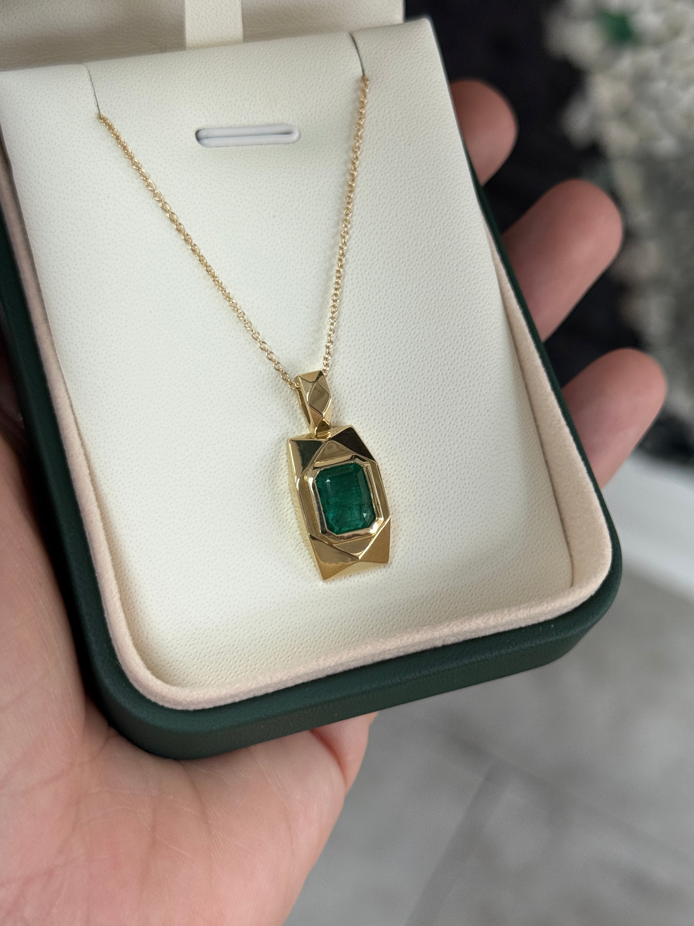 14K gold emerald dog tag pendant with 2.35 carats of Colombian emeralds, featuring a sleek and polished design.
