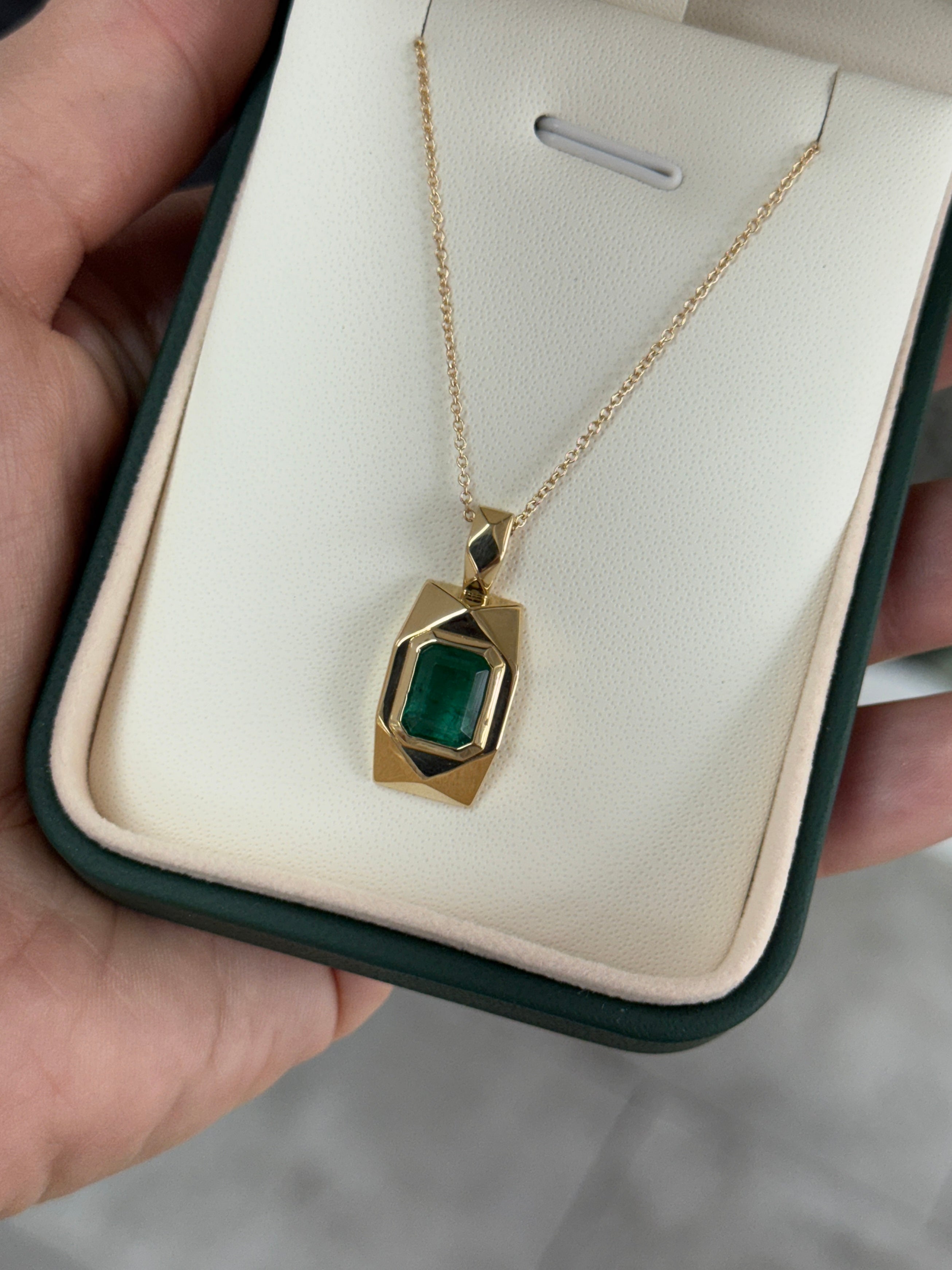 14K emerald dog tag pendant with 2.35 carats of vibrant Colombian emeralds, featuring a sleek, polished design.