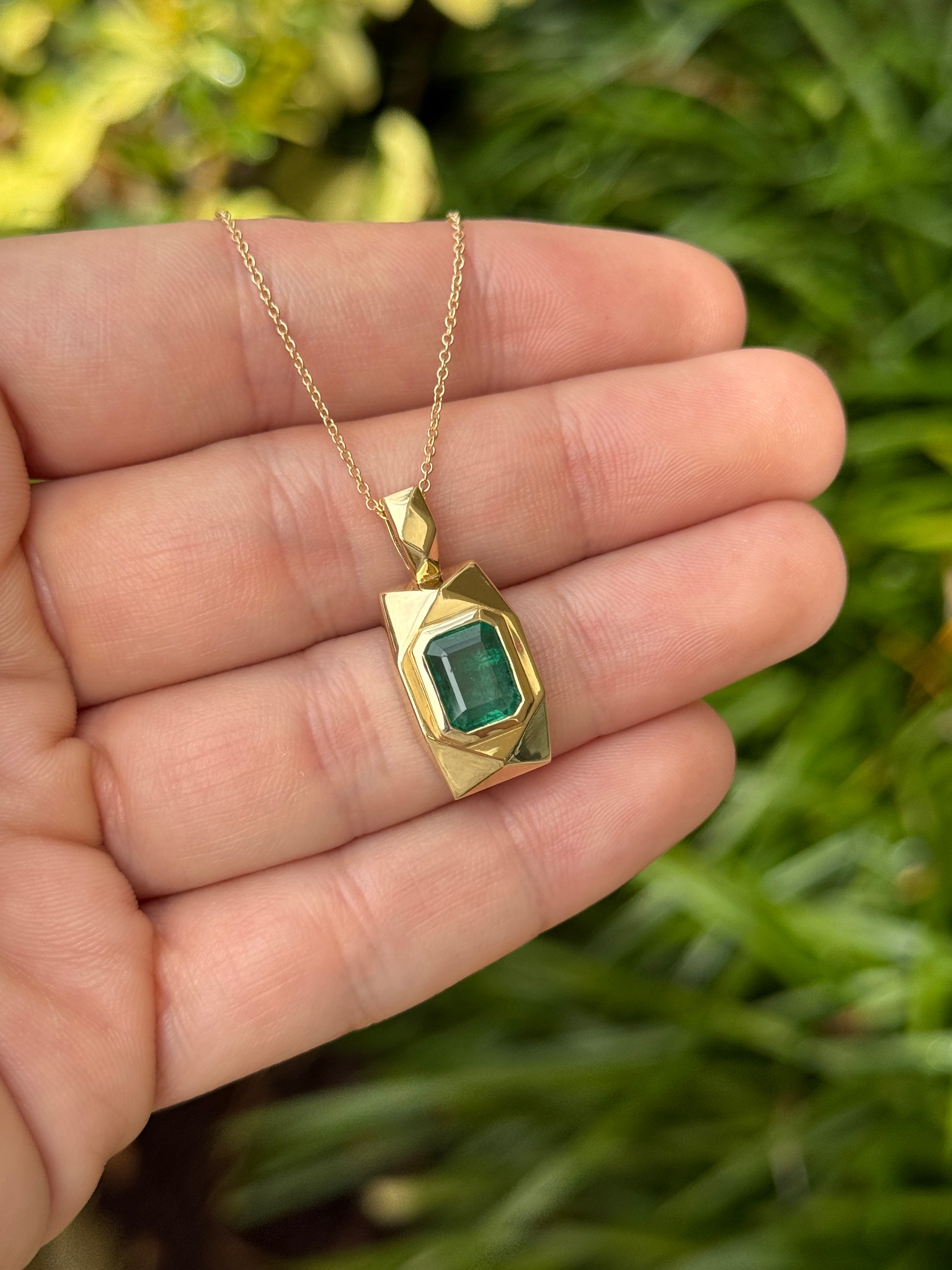 14K gold emerald dog tag pendant with 2.35 carats of vibrant Colombian emeralds, showcasing a sleek and elegant jewelry design.