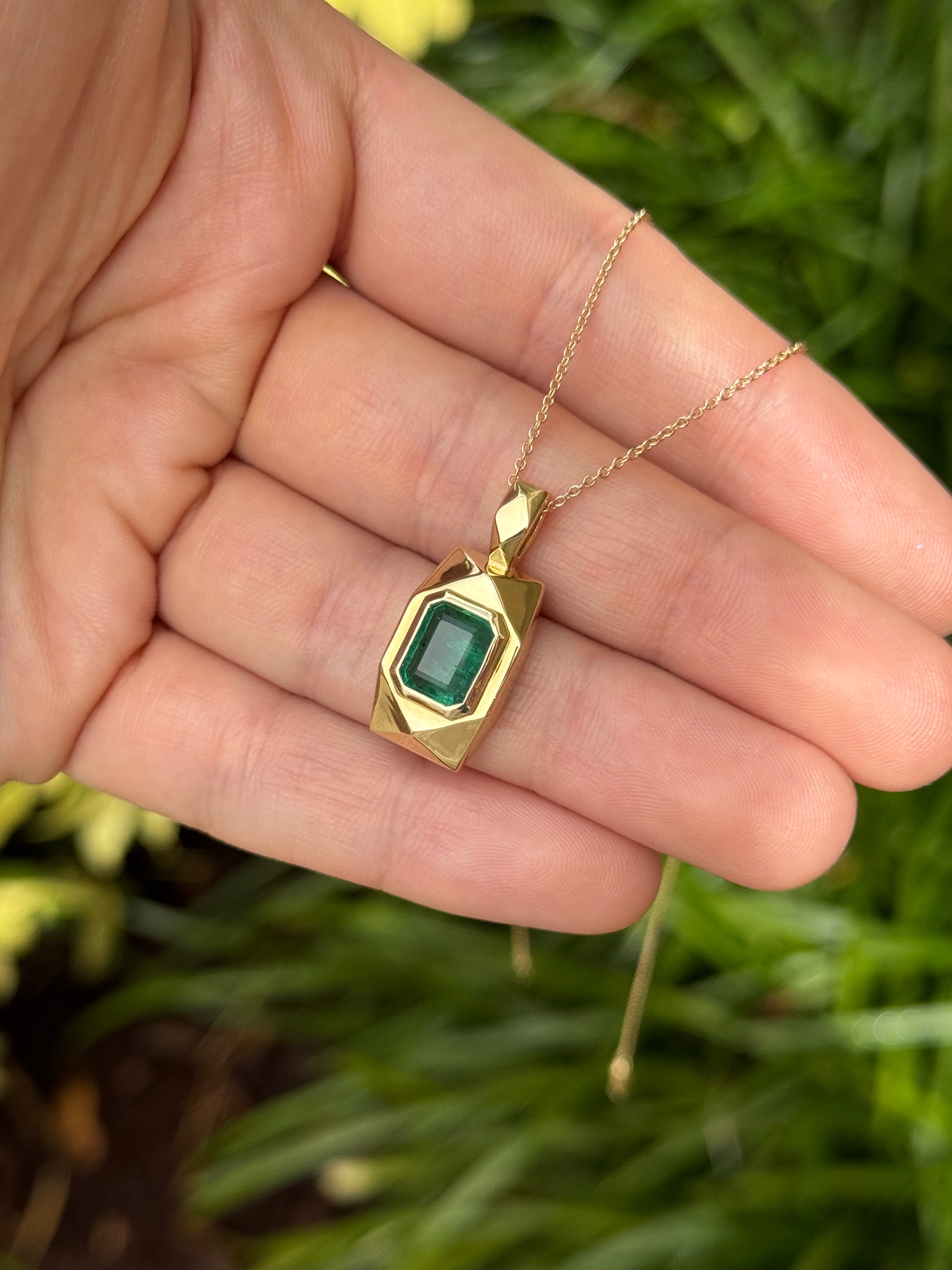 Emerald dog tag pendant with 2.35 carats in 14K gold, featuring vibrant Colombian emeralds and a sleek, polished design.