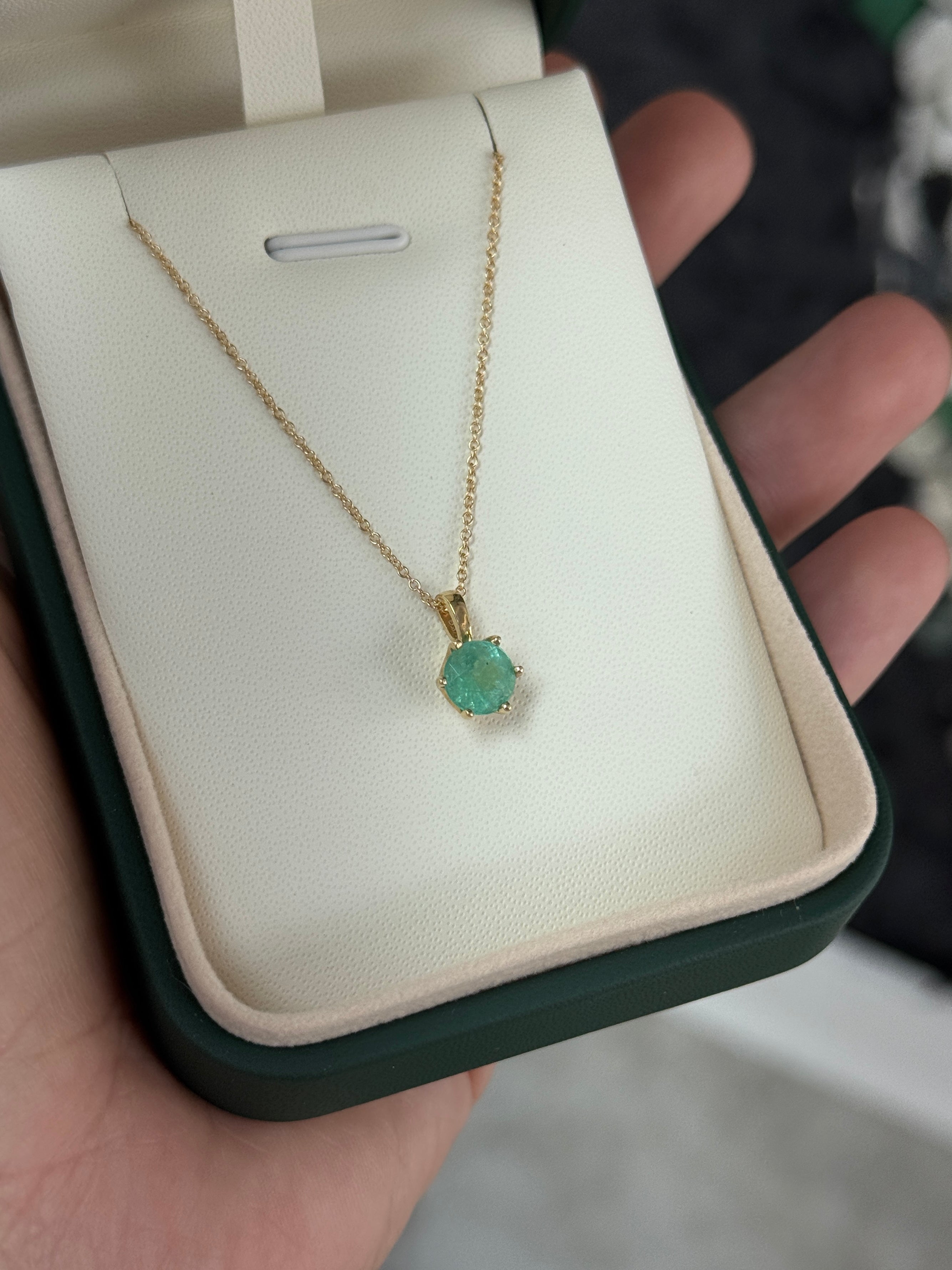 14K gold Tiffany solitaire necklace with 1.14ct round emerald by JR Colombian Emeralds, showcasing the elegant pendant design.