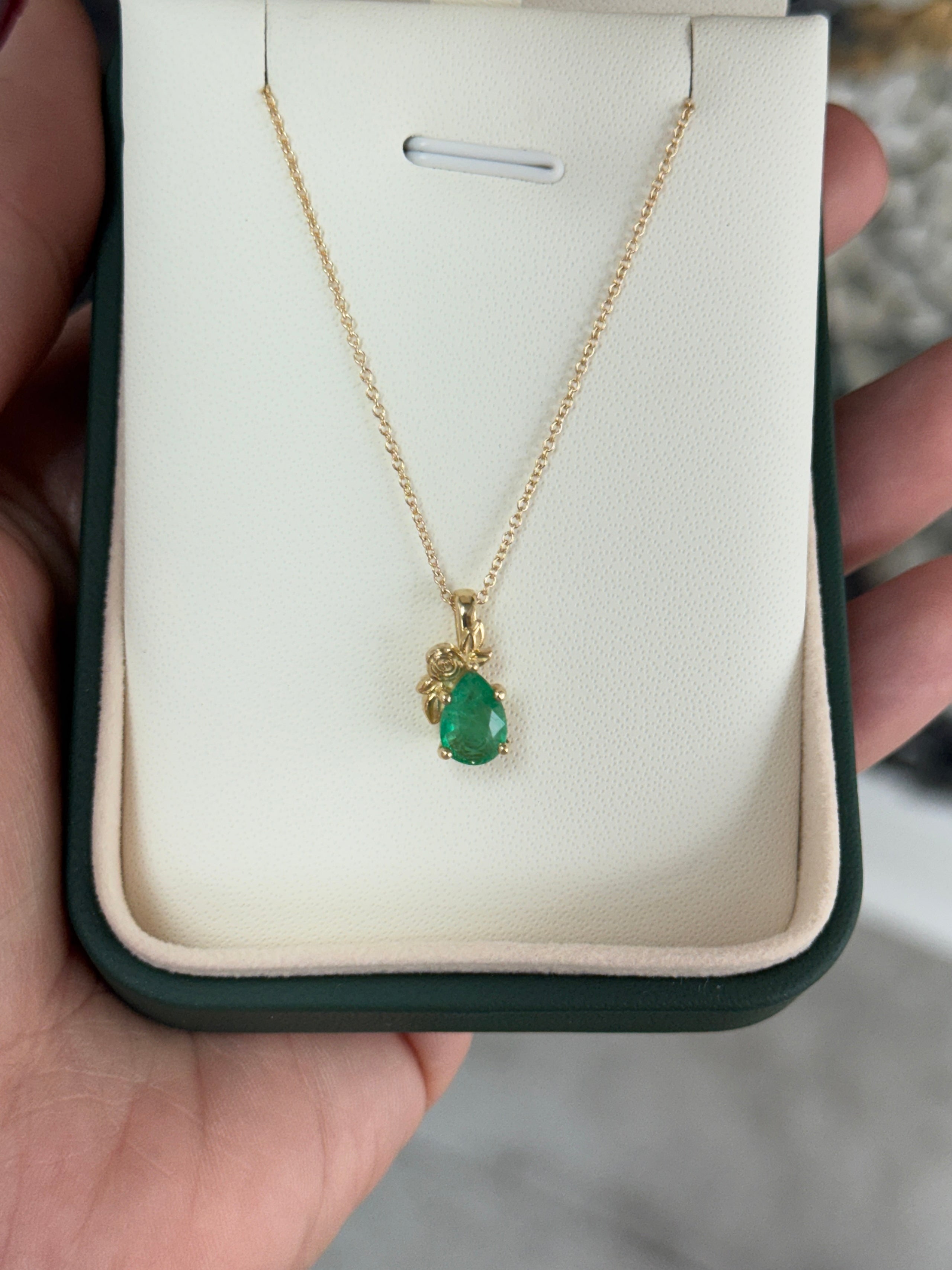 14K gold pendant necklace with a 1.0ct natural medium green pear-cut emerald set in a floral solitaire design by JR Colombian Emeralds